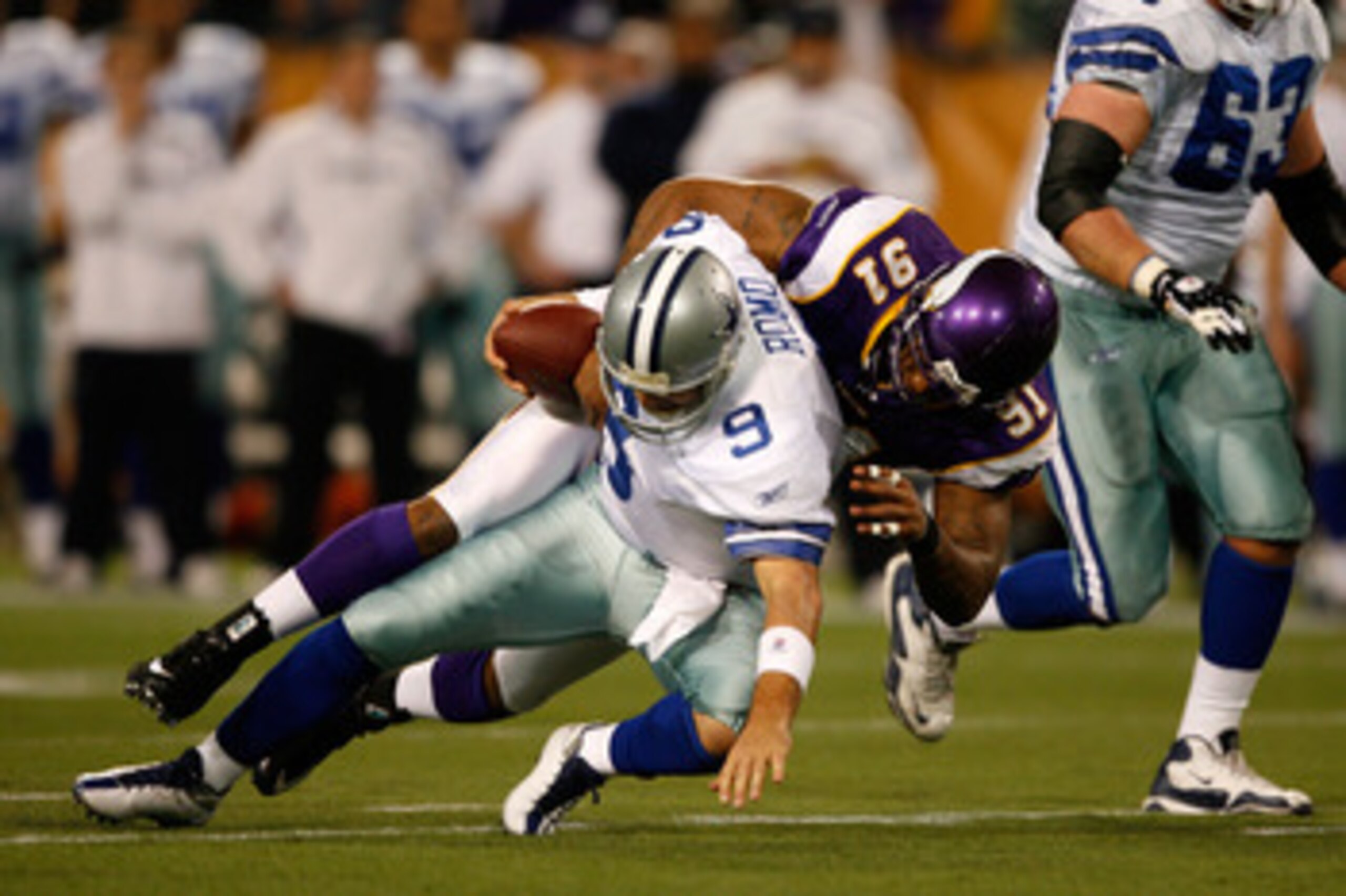 MINNEAPOLIS - JANUARY 17: Quarterback Tony Romo #9 of the Dallas Cowboys is sacked by defensive end Ray Edwards #91 of the Minnesota Vikings in the first quarter during the NFC Divisional Playoff Game at Hubert H. Humphrey Metrodome on January 17, 2010 i MINNEAPOLIS - JANUARY 17: Quarterback Tony Romo #9 of the Dallas Cowboys is sacked by defensive end Ray Edwards #91 of the Minnesota Vikings in the first quarter during the NFC Divisional Playoff Game at Hubert H. Humphrey Metrodome on January 17, 2010 i