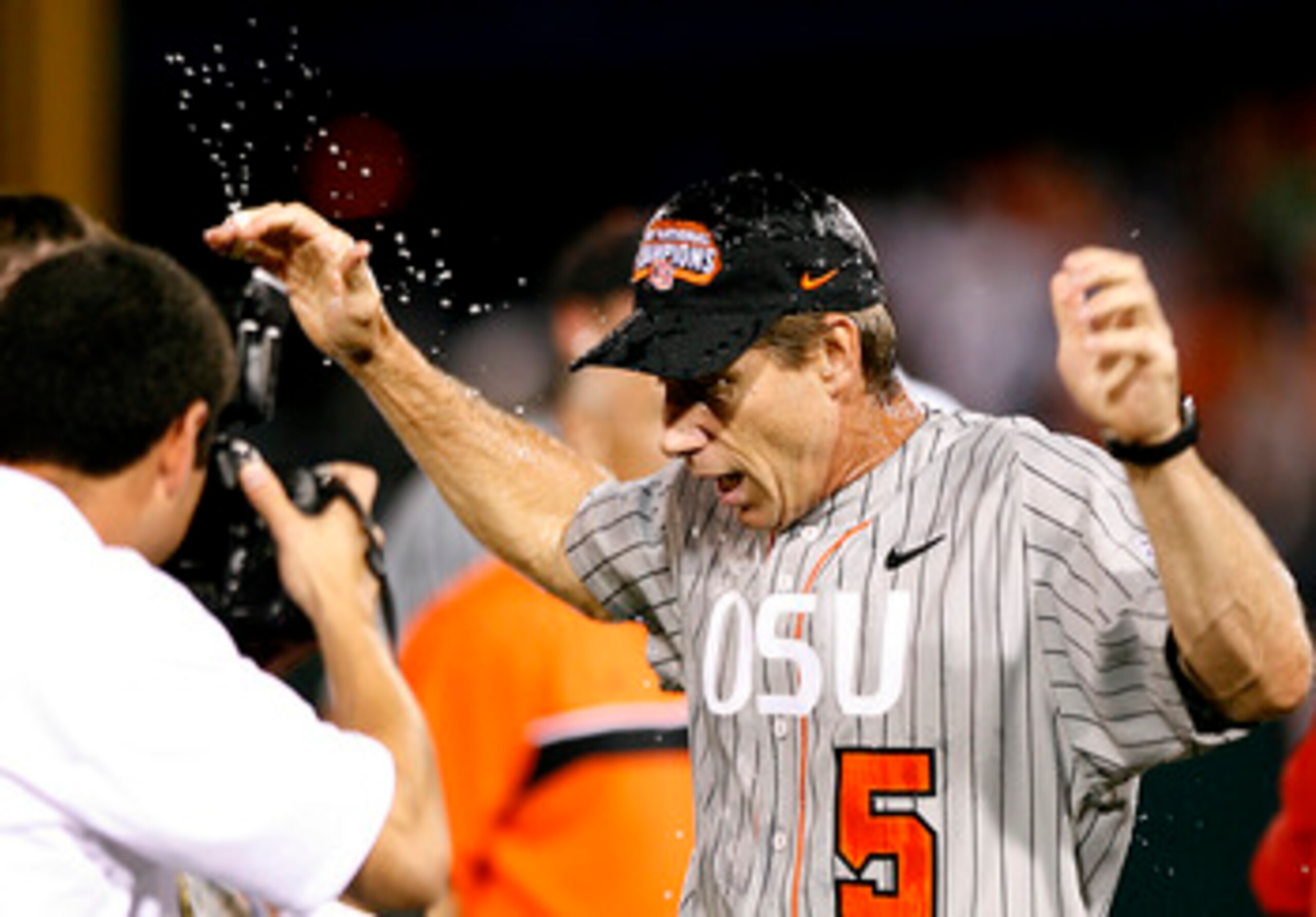 OMAHA, NE - JUNE 24:  Head coach Pat Casey #5 of the Oregon State Beavers reacts after getting doused with water following his team's 9-3 win over the North Carolina Tar Heels to claim a second straight NCAA Championship in Game 2 of the NCAA College Worl