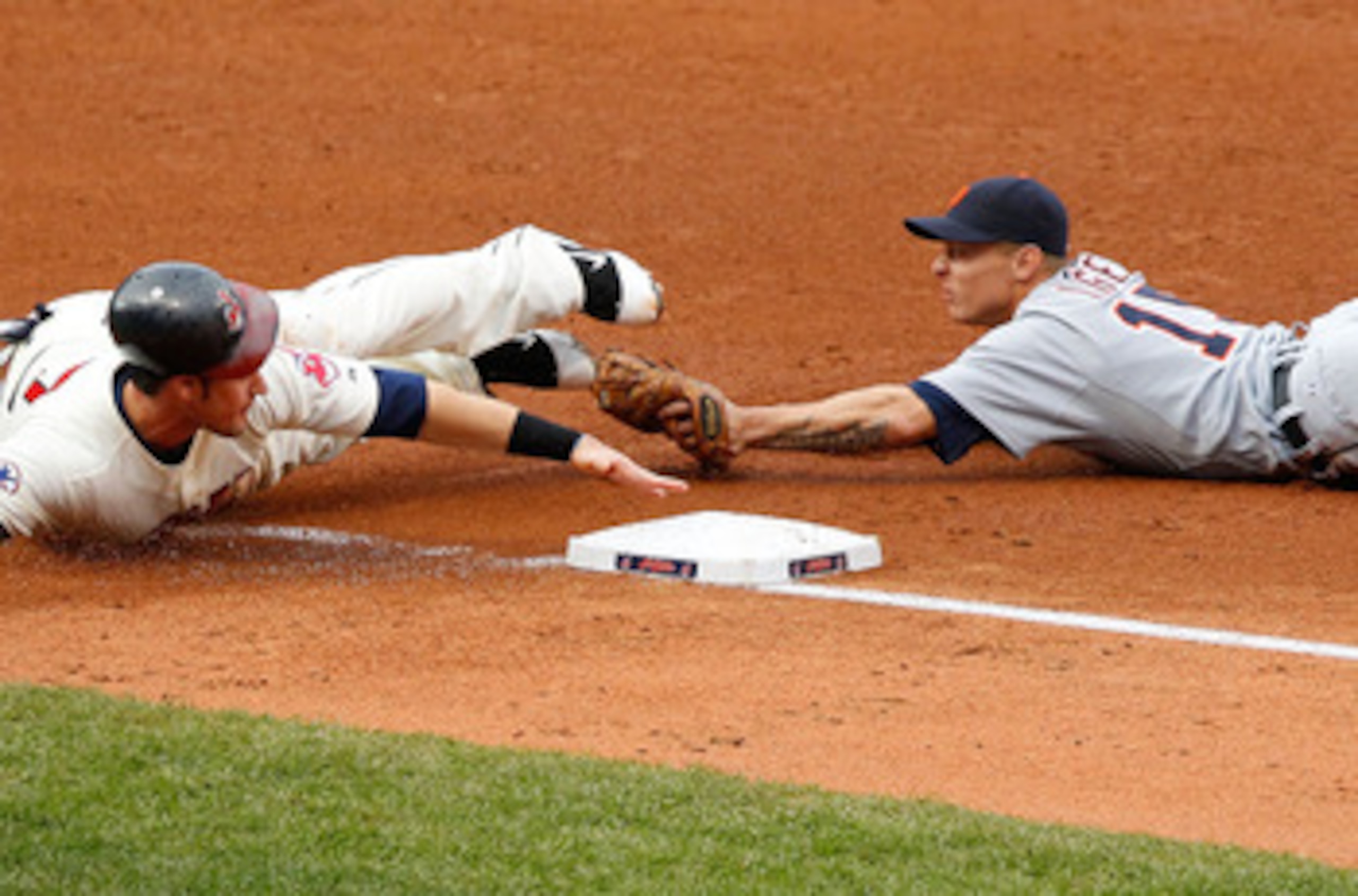 CLEVELAND - APRIL 30:  Matt LaPorta #7 of the Cleveland Indians is tagged out at third base by Brandon Inge #15 of the Detroit Tigers during the game on April 30, 2011 at Progressive Field in Cleveland, Ohio.  (Photo by Jared Wickerham/Getty Images)