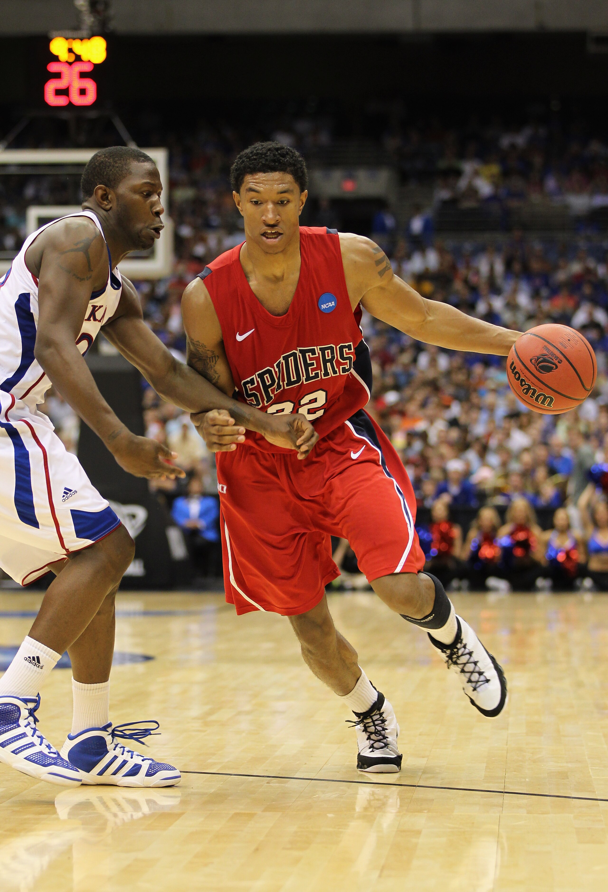 SAN ANTONIO, TX - MARCH 25: Justin Harper #32 of the Richmond Spiders drives against the Kansas Jayhawks during the southwest regional of the 2011 NCAA men's basketball tournament at the Alamodome on March 25, 2011 in San Antonio, Texas. Kansas defeated SAN ANTONIO, TX - MARCH 25: Justin Harper #32 of the Richmond Spiders drives against the Kansas Jayhawks during the southwest regional of the 2011 NCAA men's basketball tournament at the Alamodome on March 25, 2011 in San Antonio, Texas. Kansas defeated