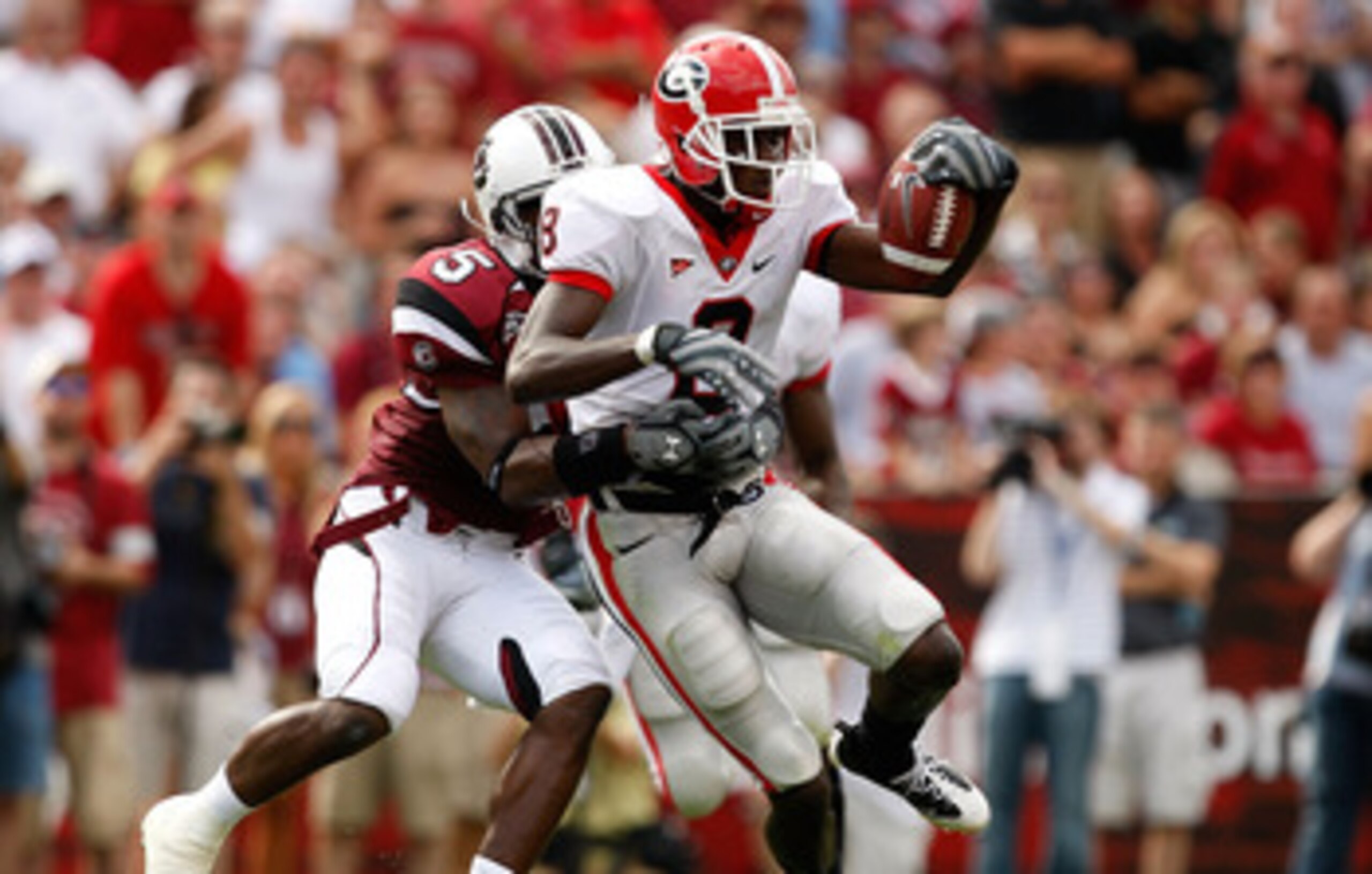 COLUMBIA, SC - SEPTEMBER 13:  A.J. Green #8 of the Georgia Bulldogs tries to break a tackle by Carlos Thomas #5 of the South Carolina Gamecocks during their game September 13, 2008 at Williams-Brice Stadium in Columbia, South Carolina.  (Photo by Streeter
