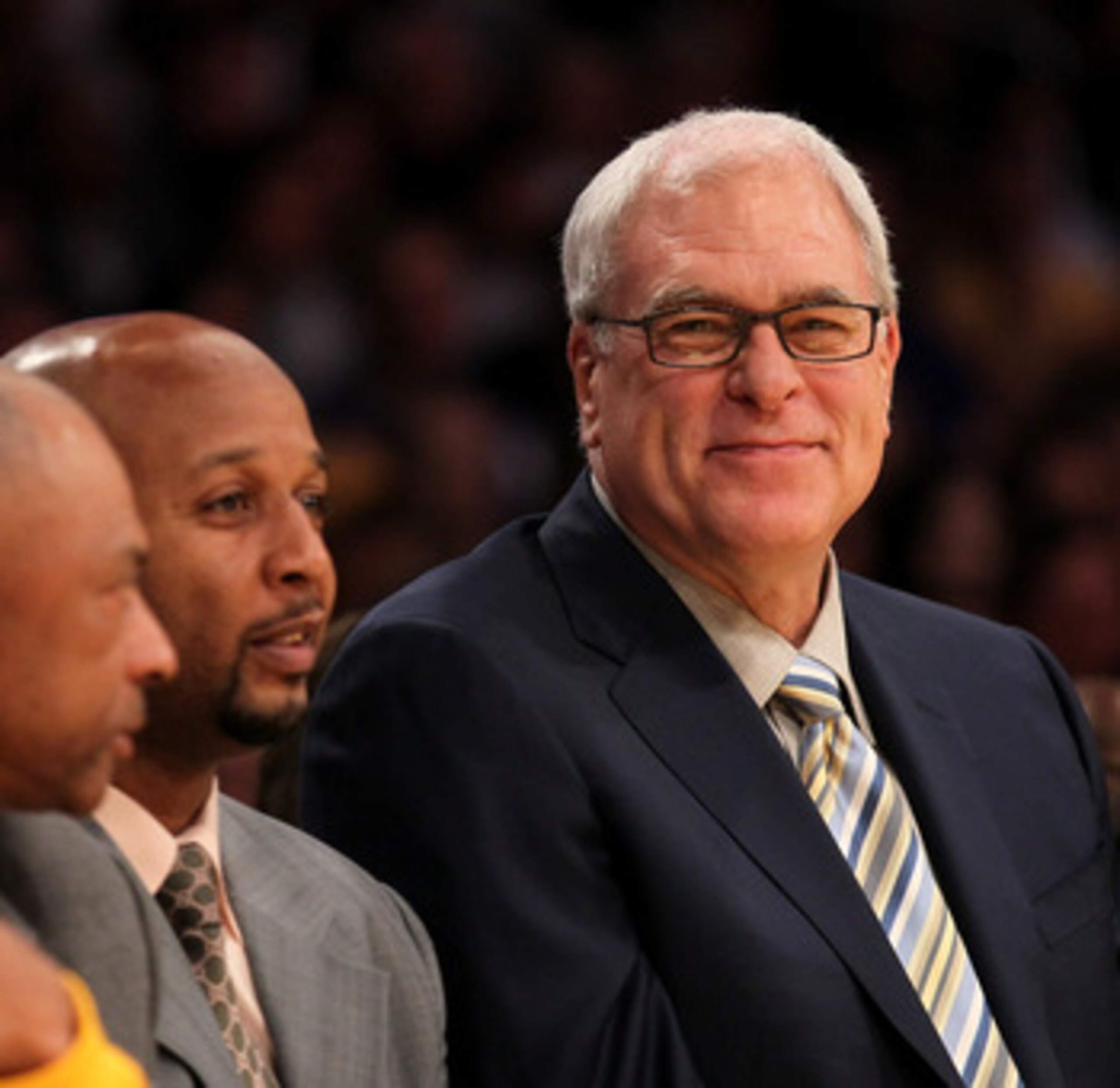 LOS ANGELES, CA - NOVEMBER 05:  Head coach Phil Jackson (L) of the Los Angeles Lakers smiles on the bench next to assistants Brian Shaw (C) and Jim Cleamons during the game with the Toronto Raptors at Staples Center on November 5, 2010 in Los Angeles, Cal