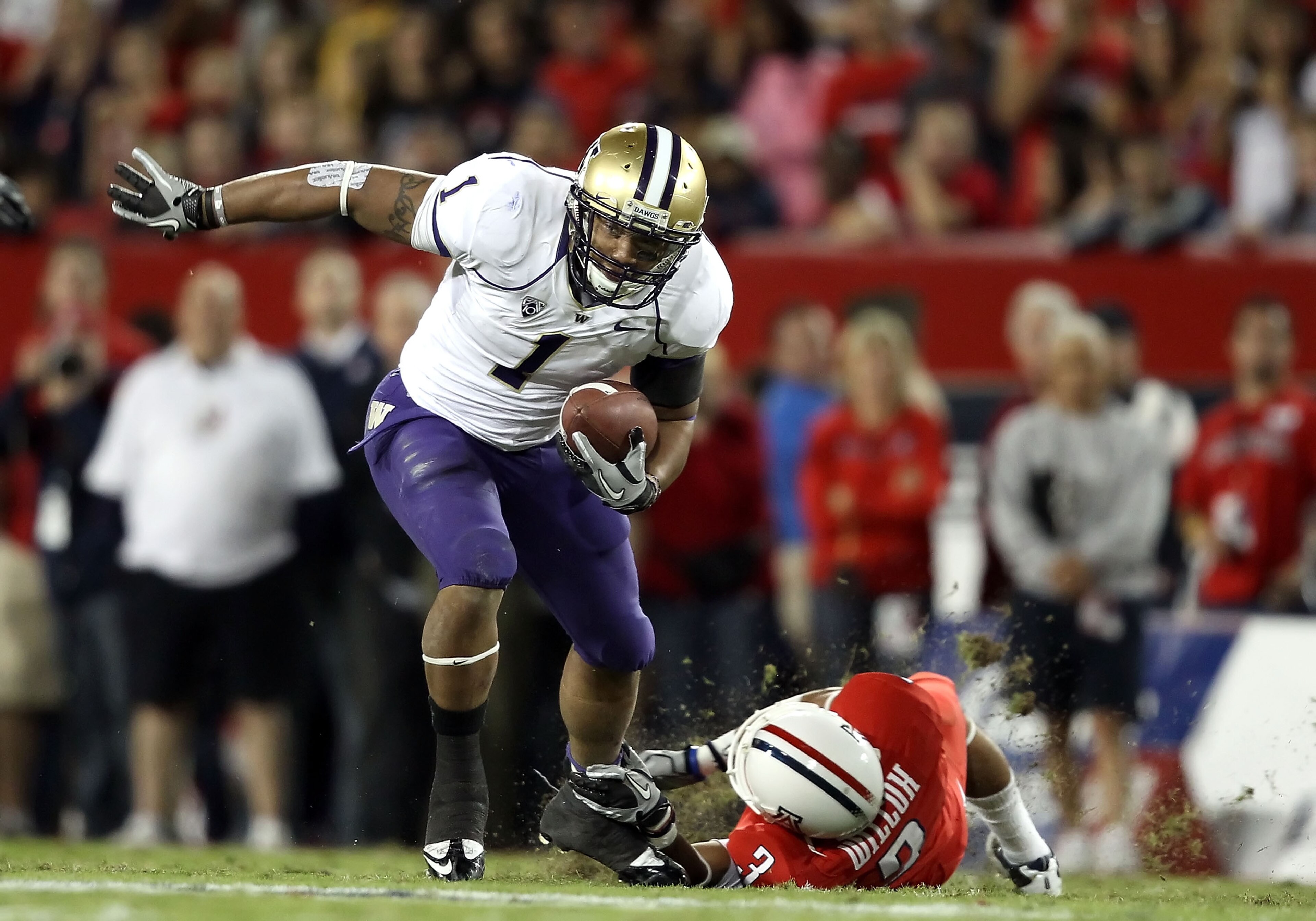 TUCSON, AZ - OCTOBER 23: Runningback Chris Polk #1 of the Washington Huskies rushes the football during the college football game against the Arizona Wildcats at Arizona Stadium on October 23, 2010 in Tucson, Arizona. The Wildcats defeated the Huskies 44 TUCSON, AZ - OCTOBER 23: Runningback Chris Polk #1 of the Washington Huskies rushes the football during the college football game against the Arizona Wildcats at Arizona Stadium on October 23, 2010 in Tucson, Arizona. The Wildcats defeated the Huskies 44