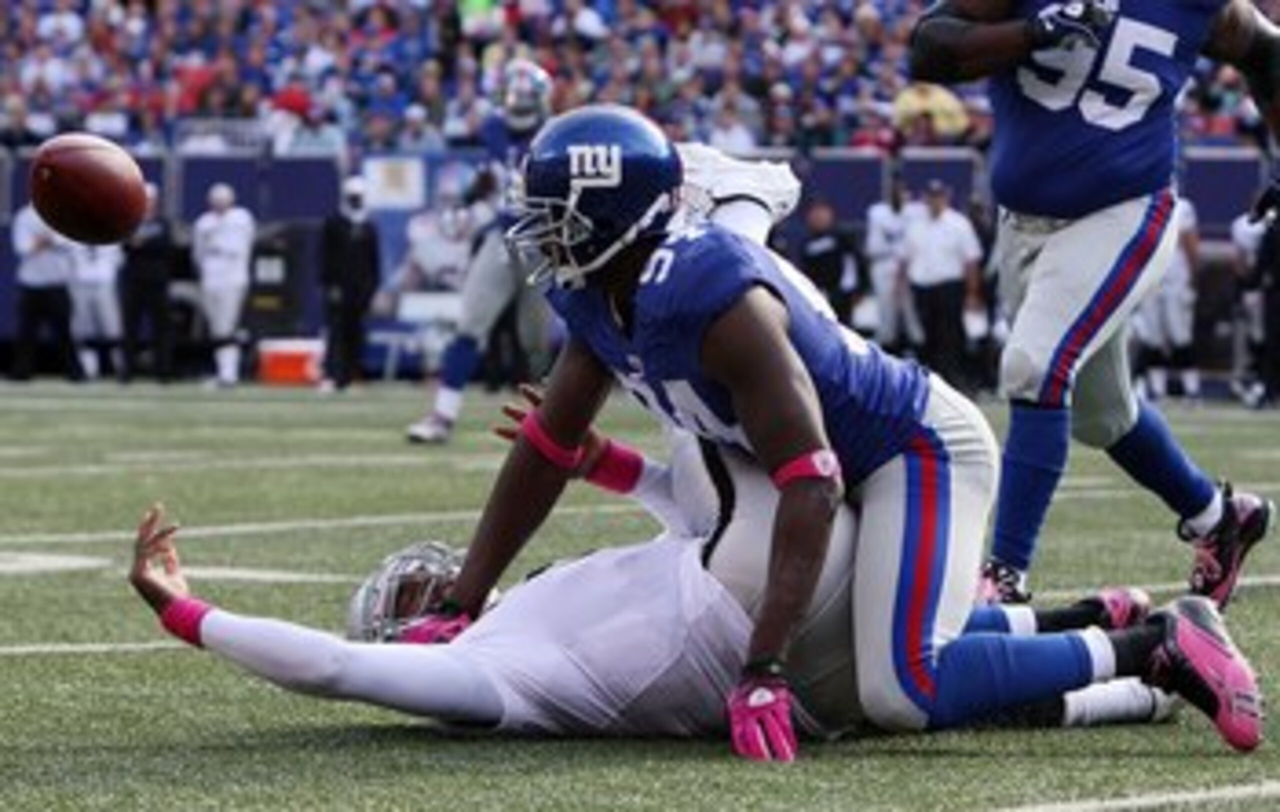 EAST RUTHERFORD, NJ - OCTOBER 11: Mathias Kiwanuka #94 of the New York Giants forces a fumble against JaMarcus Russell #2 of the Oakland Raiders on October 11, 2009 at Giants Stadium in East Rutherford, New Jersey. The Giants defeated the Raiders 44-7. EAST RUTHERFORD, NJ - OCTOBER 11: Mathias Kiwanuka #94 of the New York Giants forces a fumble against JaMarcus Russell #2 of the Oakland Raiders on October 11, 2009 at Giants Stadium in East Rutherford, New Jersey. The Giants defeated the Raiders 44-7.