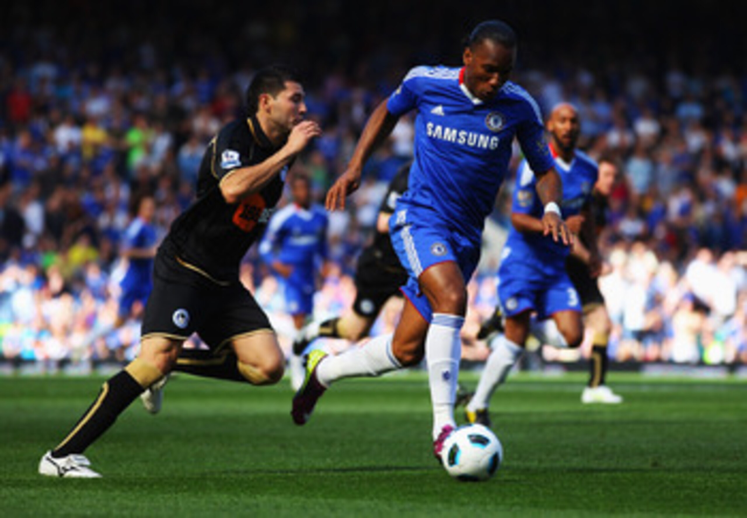 LONDON, ENGLAND - APRIL 09:  Didier Drogba of Chelsea evades Antolin Alcaraz of Wigan Athletic during the Barclays Premier League match between Chelsea and Wigan Athletic at Stamford Bridge on April 9, 2011 in London, England.  (Photo by Clive Rose/Getty