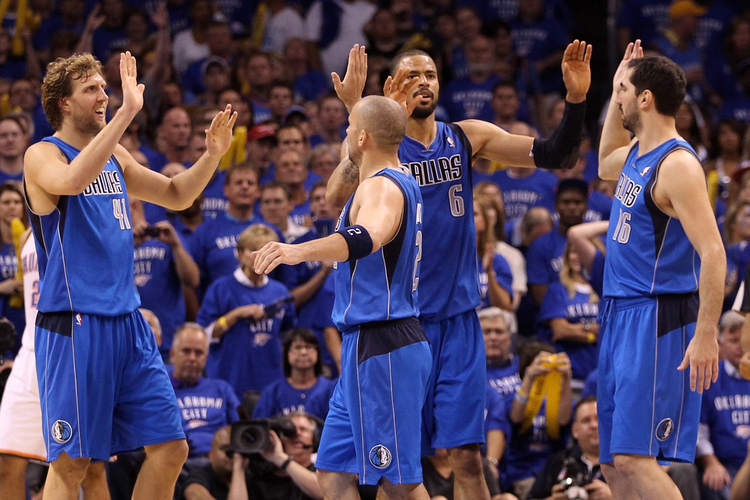 OKLAHOMA CITY, OK - MAY 23:  (L-R) Dirk Nowitzki #41, Jason Kidd #2, Tyson Chandler #6 and Peja Stojakovic #16 of the Dallas Mavericks react in the fourth quarter while taking on the Oklahoma City Thunder in Game Four of the Western Conference Finals duri