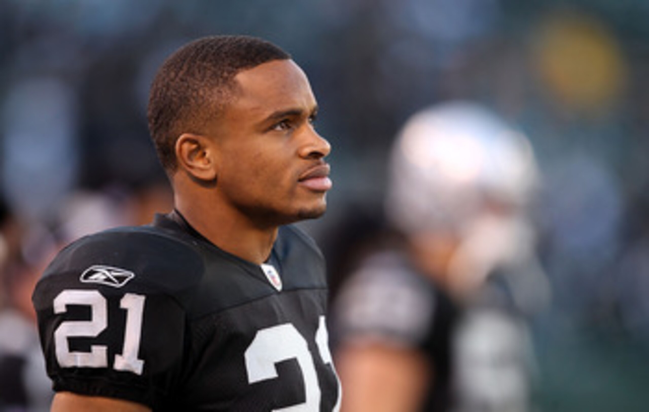 OAKLAND, CA - NOVEMBER 28:  Nnamdi Asomugha #21 of the Oakland Raiders stands on the sidelines during the closing minutes of their loss to the Miami Dolphins at Oakland-Alameda County Coliseum on November 28, 2010 in Oakland, California.  (Photo by Ezra S