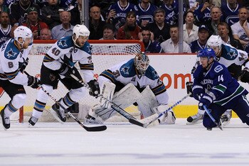 VANCOUVER, CANADA - MAY 24:  Joe Pavelski #8, Kent Huskins #40, goaltender Antti Niemi #31, and Marc-Edouard Vlasic #44 of the San Jose Sharks defend the play of Alex Burrows #14 of the Vancouver Canucks in Game Five of the Western Conference Finals durin