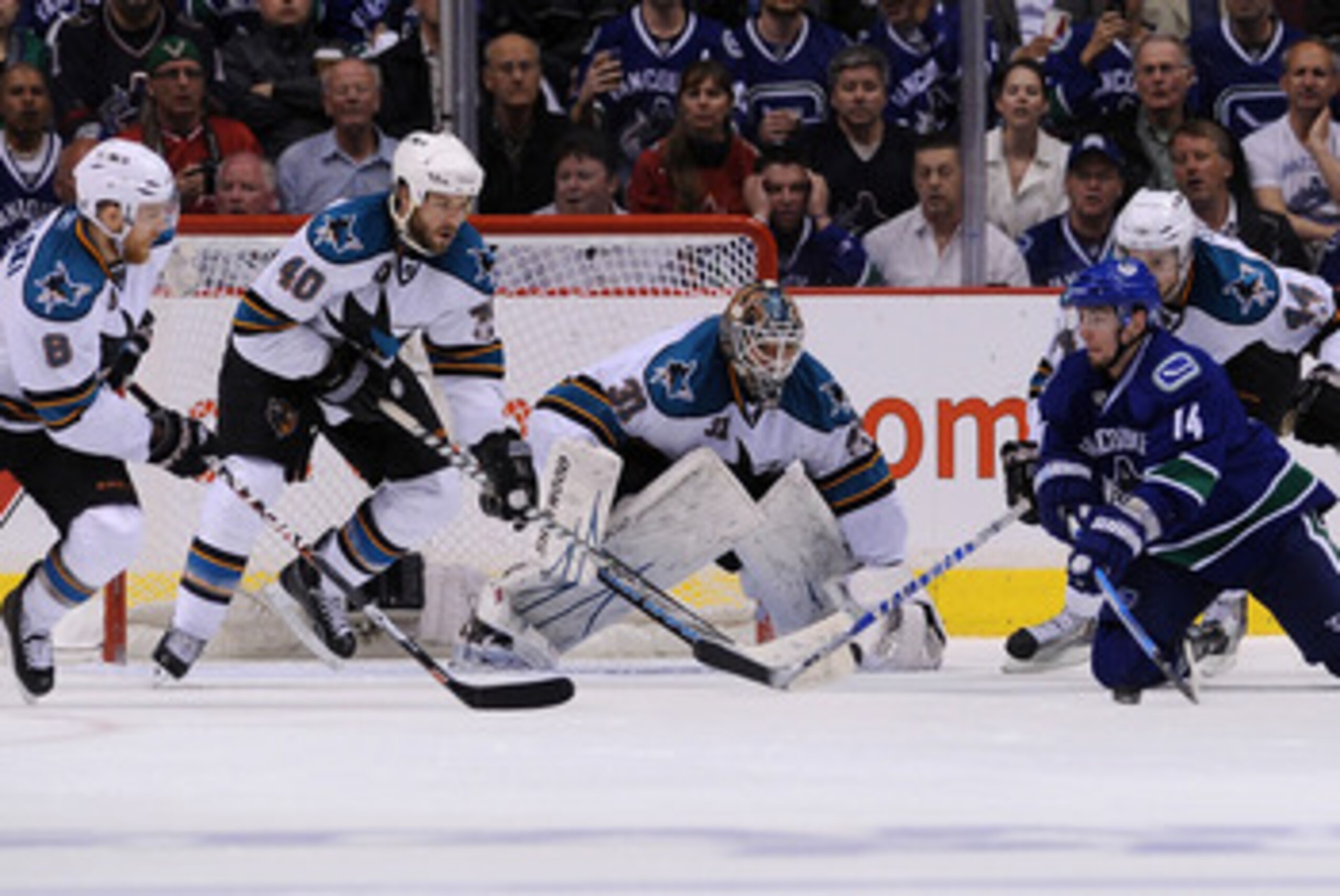 VANCOUVER, CANADA - MAY 24:  Joe Pavelski #8, Kent Huskins #40, goaltender Antti Niemi #31, and Marc-Edouard Vlasic #44 of the San Jose Sharks defend the play of Alex Burrows #14 of the Vancouver Canucks in Game Five of the Western Conference Finals durin
