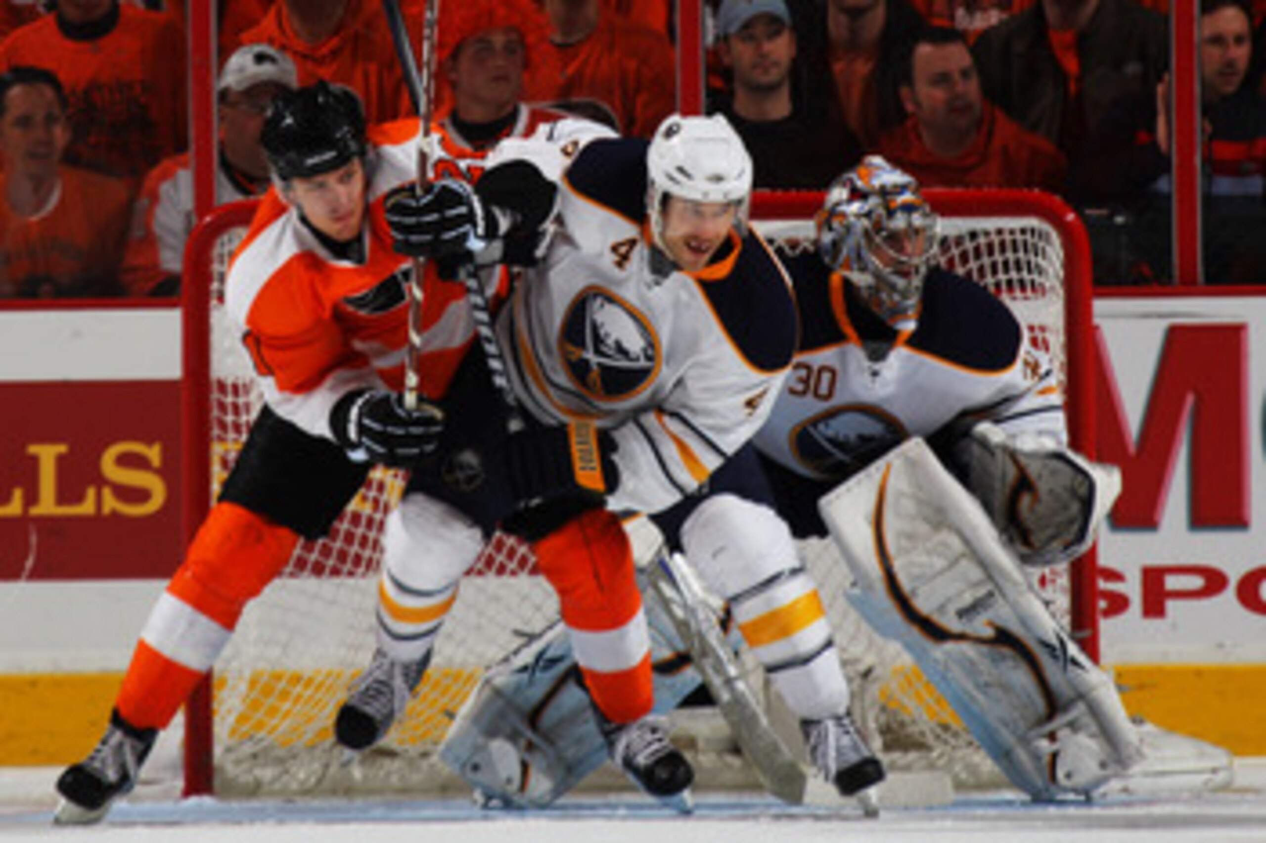 PHILADELPHIA, PA - APRIL 22:  Steve Montador #4 of the Buffalo Sabres and James van Riemsdyk #21 of the Philadelphia Flyers vie for position in Game Five of the Eastern Conference Quarterfinals during the 2011 NHL Stanley Cup Playoffs at Wells Fargo Cente
