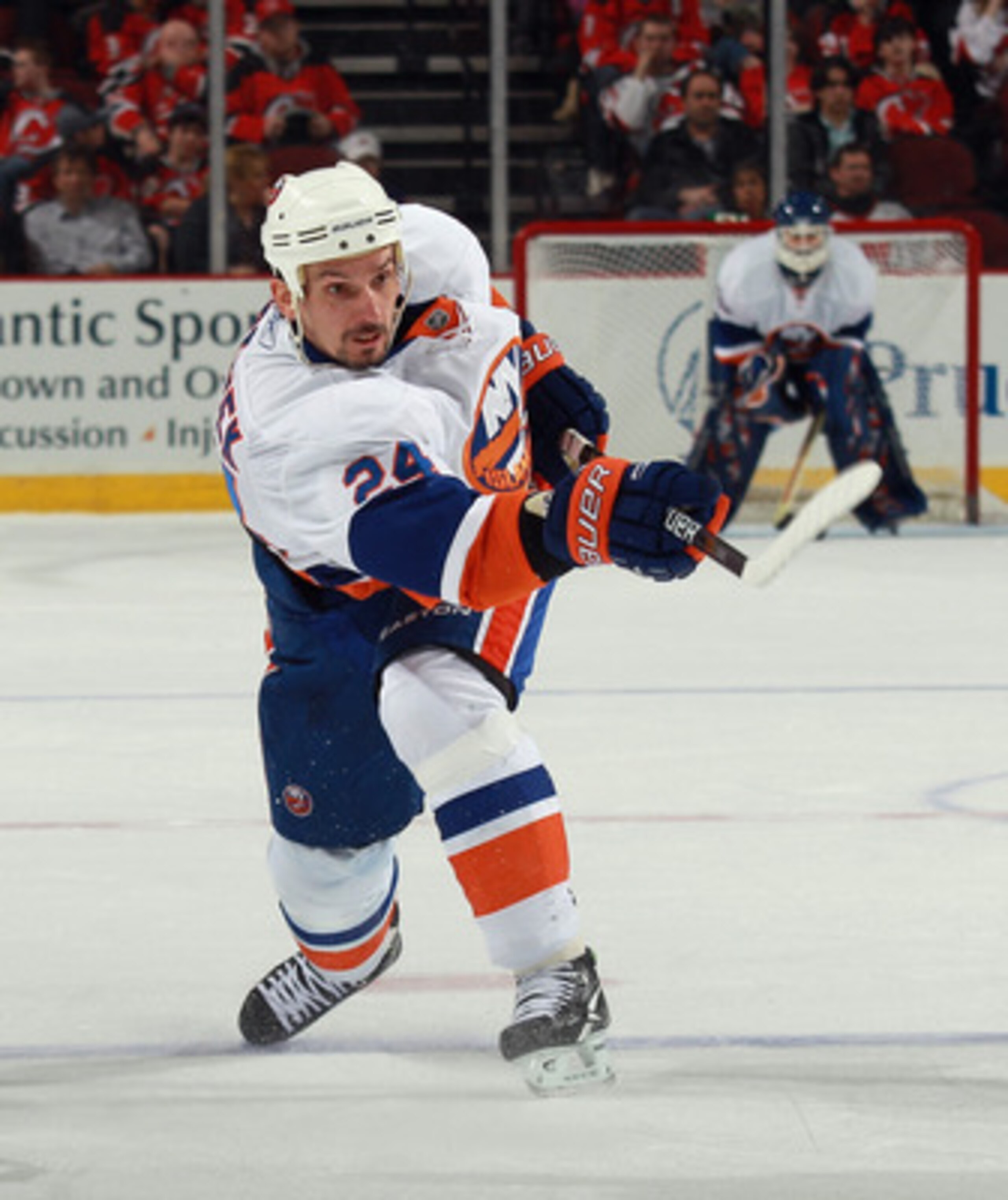 NEWARK, NJ - MARCH 30: Radek Martinek #24 of the New York Islanders shoots the puck against the New Jersey Devils at the Prudential Center on March 30, 2011 in Newark, New Jersey.  (Photo by Bruce Bennett/Getty Images)