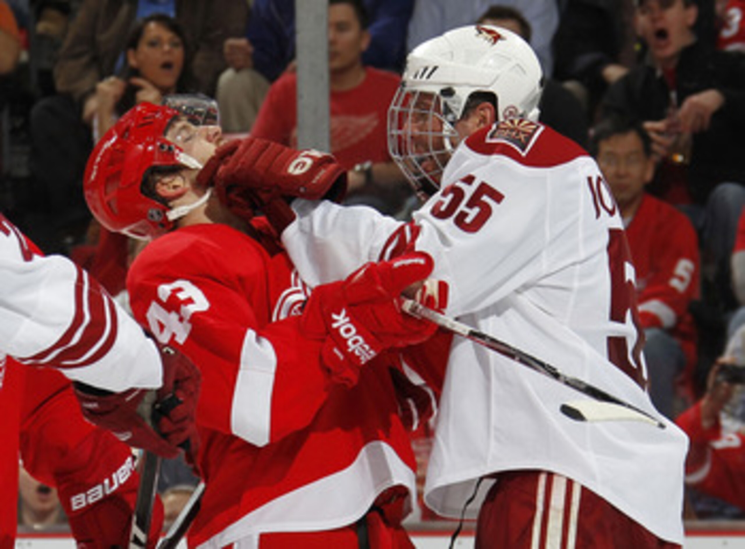 DETROIT, MI - APRIL 16:  Ed Jovanovski #55 of the Phoenix Coyotes puts a glove in the face of Darren Helm #43 of the Detroit Red Wings in Game Two of the Western Conference Quarterfinals during the 2011 Stanley Cup Playoffs at Joe Louis Arena on April 16,