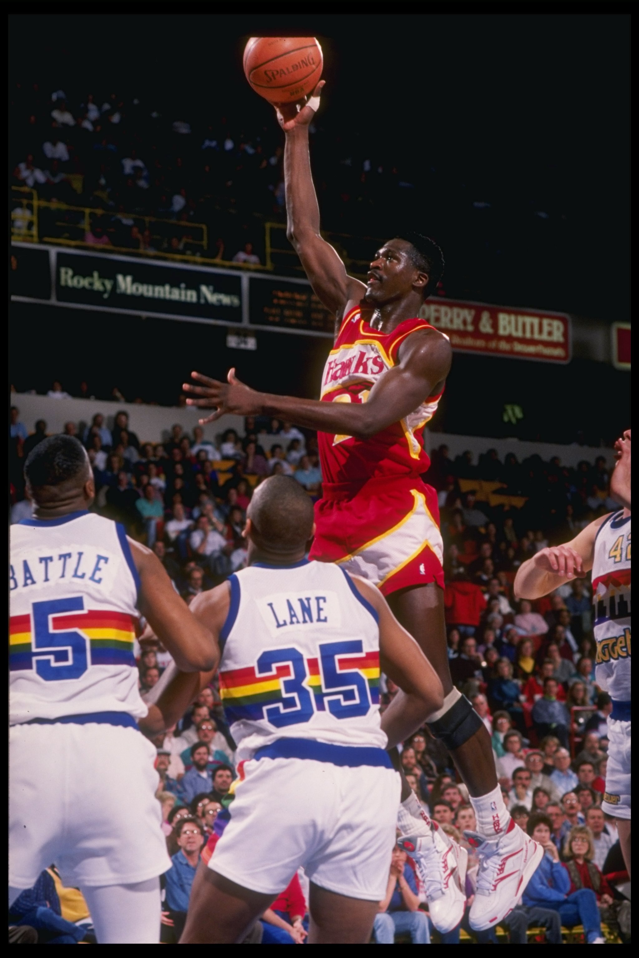 Forward Dominique Wilkins of the Atlanta Hawks jumps to the basket during a game against the Denver Nuggets at the McNichols Sports Arena in Denver, Colorado.