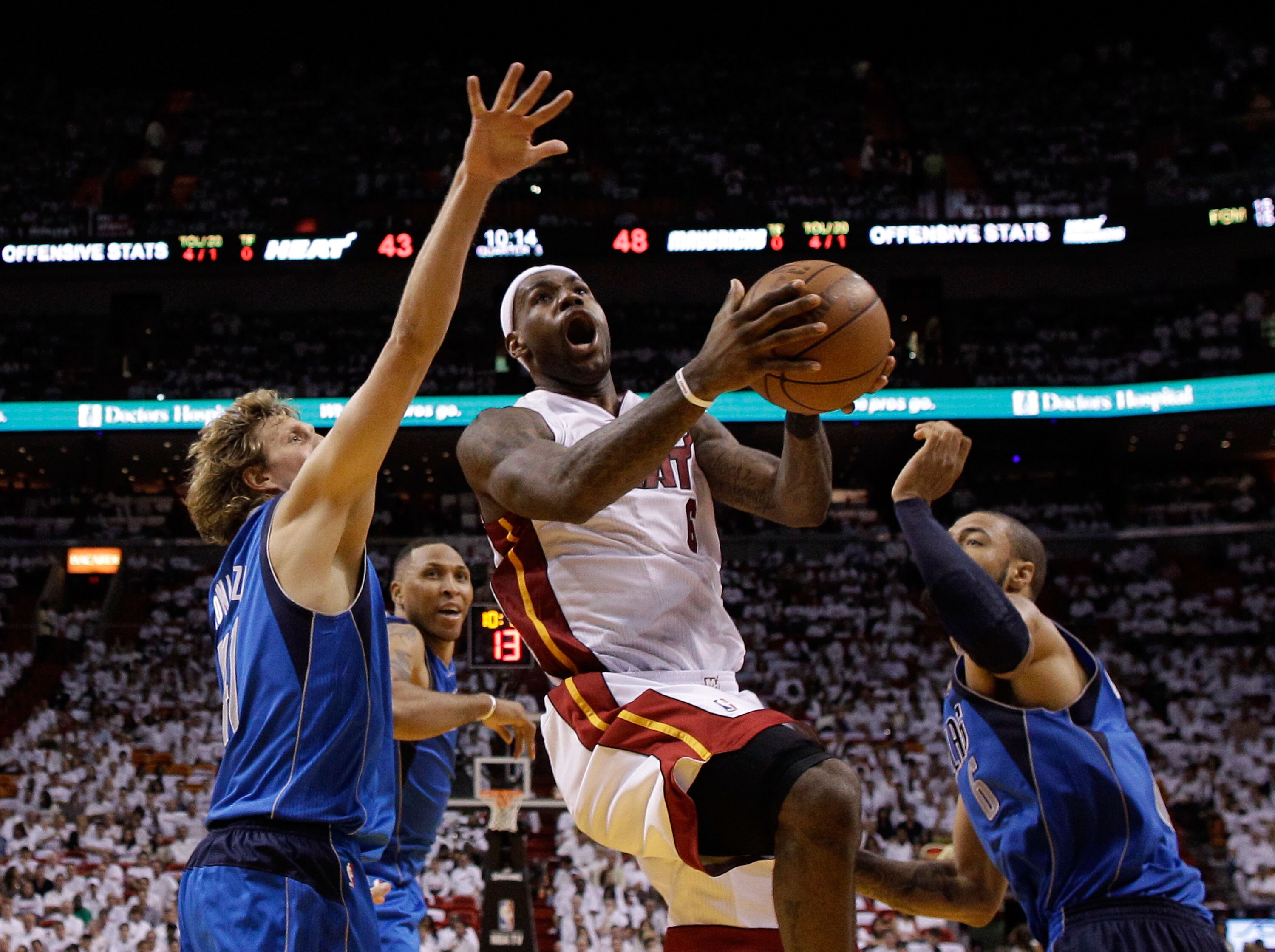 MIAMI, FL - MAY 31:  LeBron James #6 of the Miami Heat goes up for a shot between Dirk Nowitzki #41 and Tyson Chandler #6 of the Dallas Mavericks in the second half in Game One of the 2011 NBA Finals at American Airlines Arena on May 31, 2011 in Miami, Fl