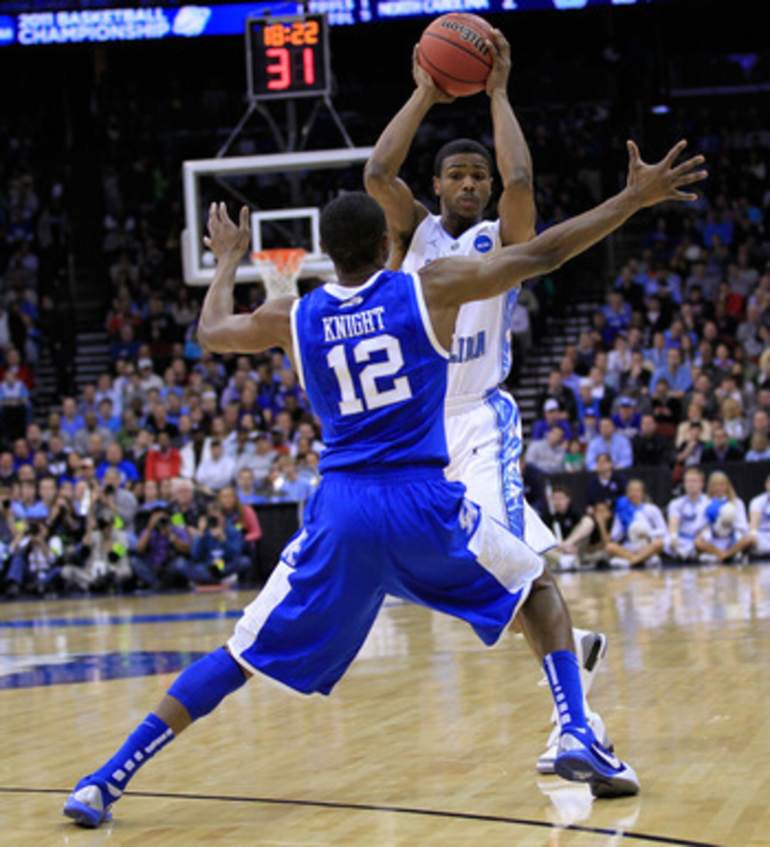 NEWARK, NJ - MARCH 27:  Brandon Knight #12 of the Kentucky Wildcats blocks Dexter Strickland #1 of the North Carolina Tar Heels during the east regional final of the 2011 NCAA men's basketball tournament at Prudential Center on March 27, 2011 in Newark, N