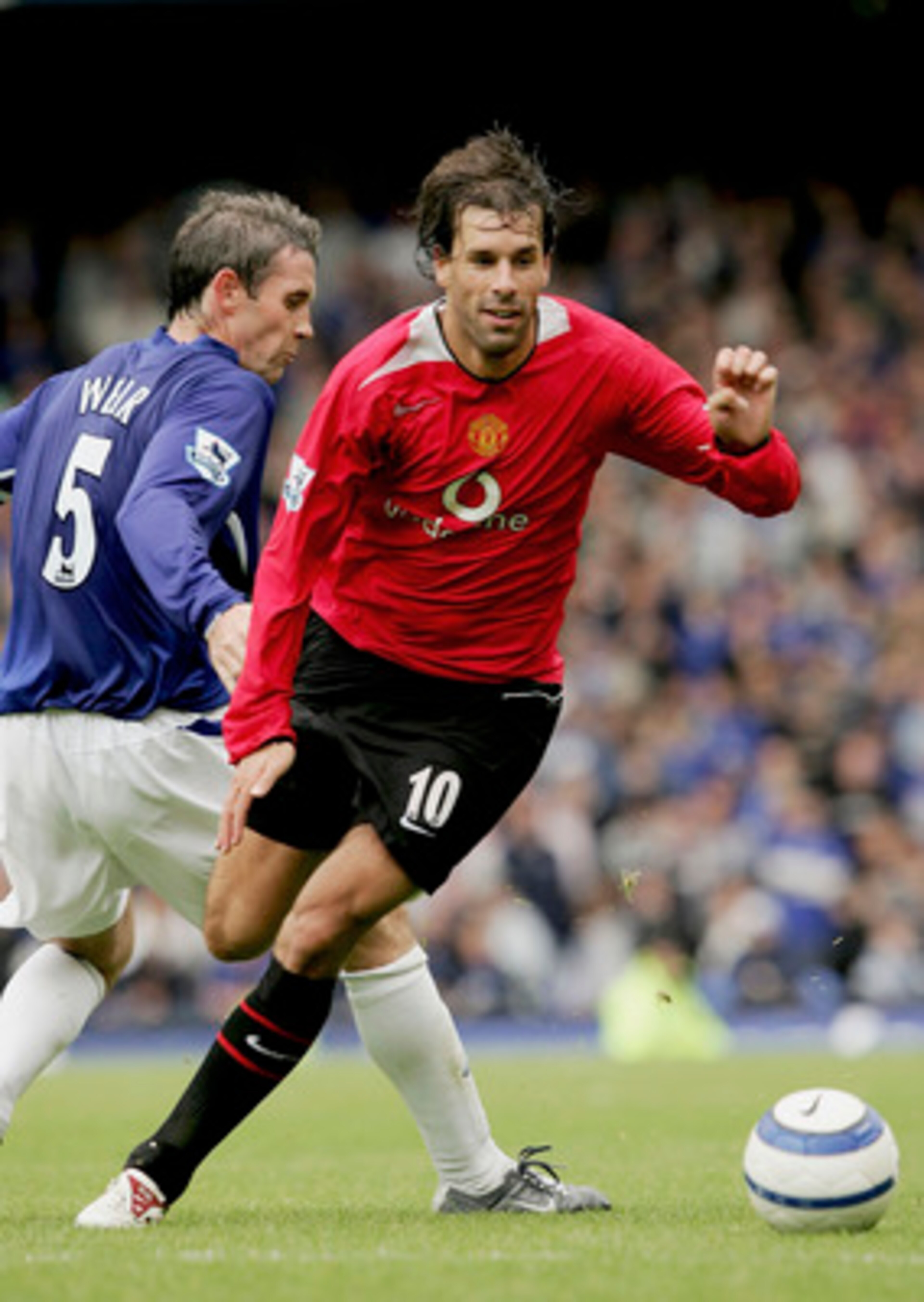 LIVERPOOL, ENGLAND -  AUGUST 13 : Ruud Van Nistelrooy of Man Utd moves away from David Weir of Everton during the Barclays Premiership match between Everton and Manchester United at Goodison Park on August 13, 2005 in Liverpool, England.  (Photo by Clive 