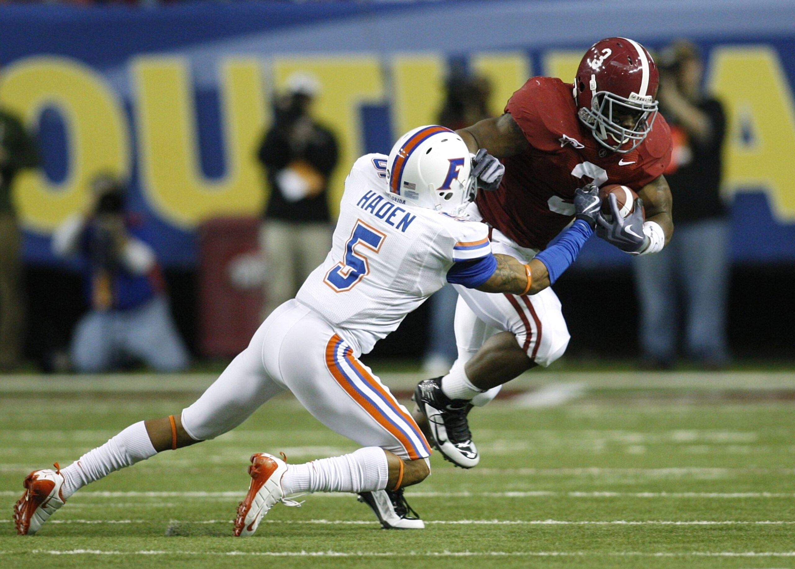 ATLANTA - DECEMBER 5:  Trent Richardson #3 of the Alabama Crimson Tide runs the ball against Joe Haden #5 of the Florida Gators during the SEC Championship game at Georgia Dome on December 5, 2009 in Atlanta, Georgia.  (Photo by Chris Graythen/Getty Image