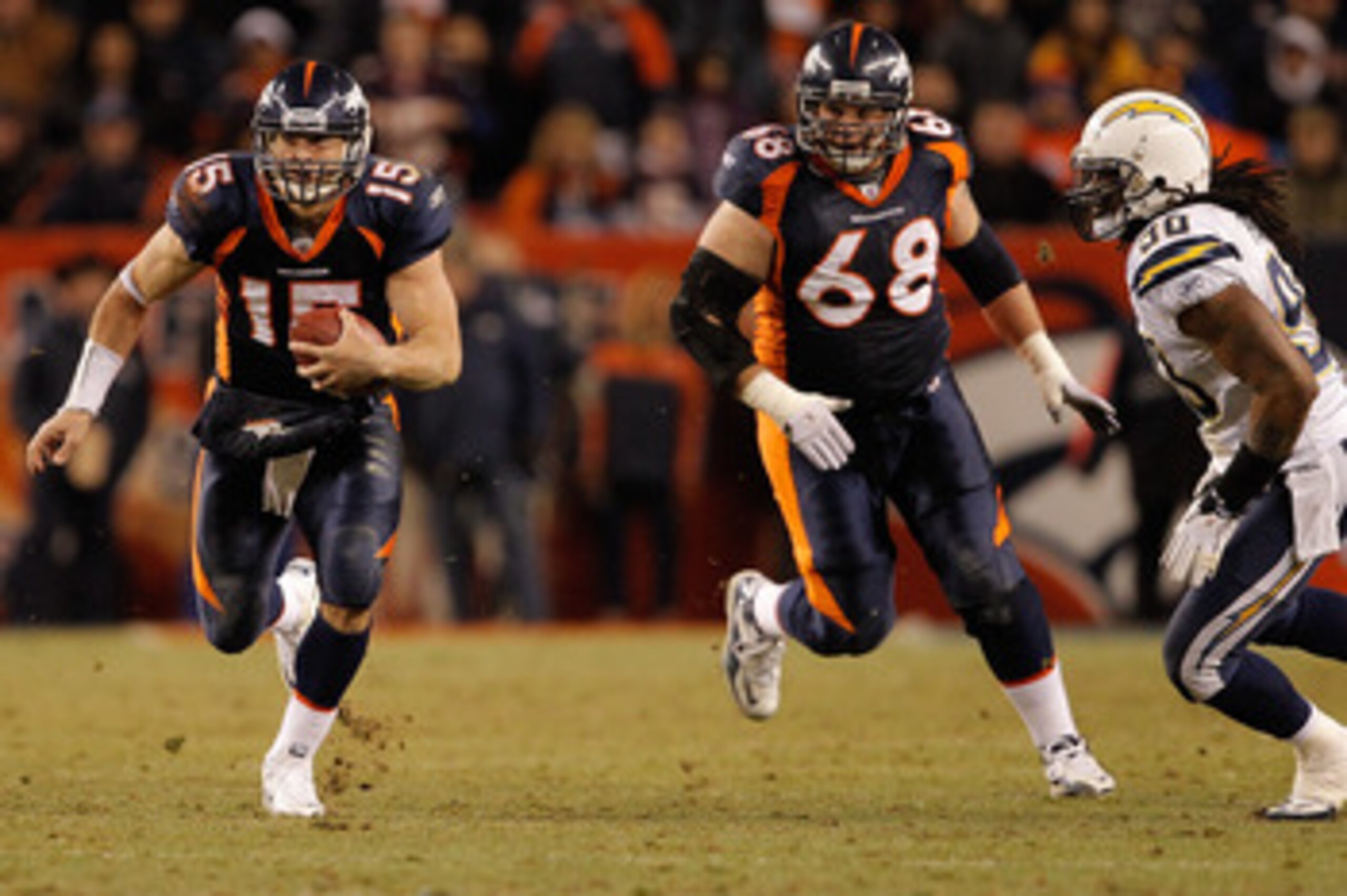 DENVER, CO - JANUARY 2: Quarterback Tim Tebow #15 of the Denver Broncos runs for a first down past linebacker Antwan Applewhite #90 of the San Diego Chargers as guard Zane Beadles #68 trails the play during the fourth quarter at INVESCO Field at Mile Hig DENVER, CO - JANUARY 2: Quarterback Tim Tebow #15 of the Denver Broncos runs for a first down past linebacker Antwan Applewhite #90 of the San Diego Chargers as guard Zane Beadles #68 trails the play during the fourth quarter at INVESCO Field at Mile Hig