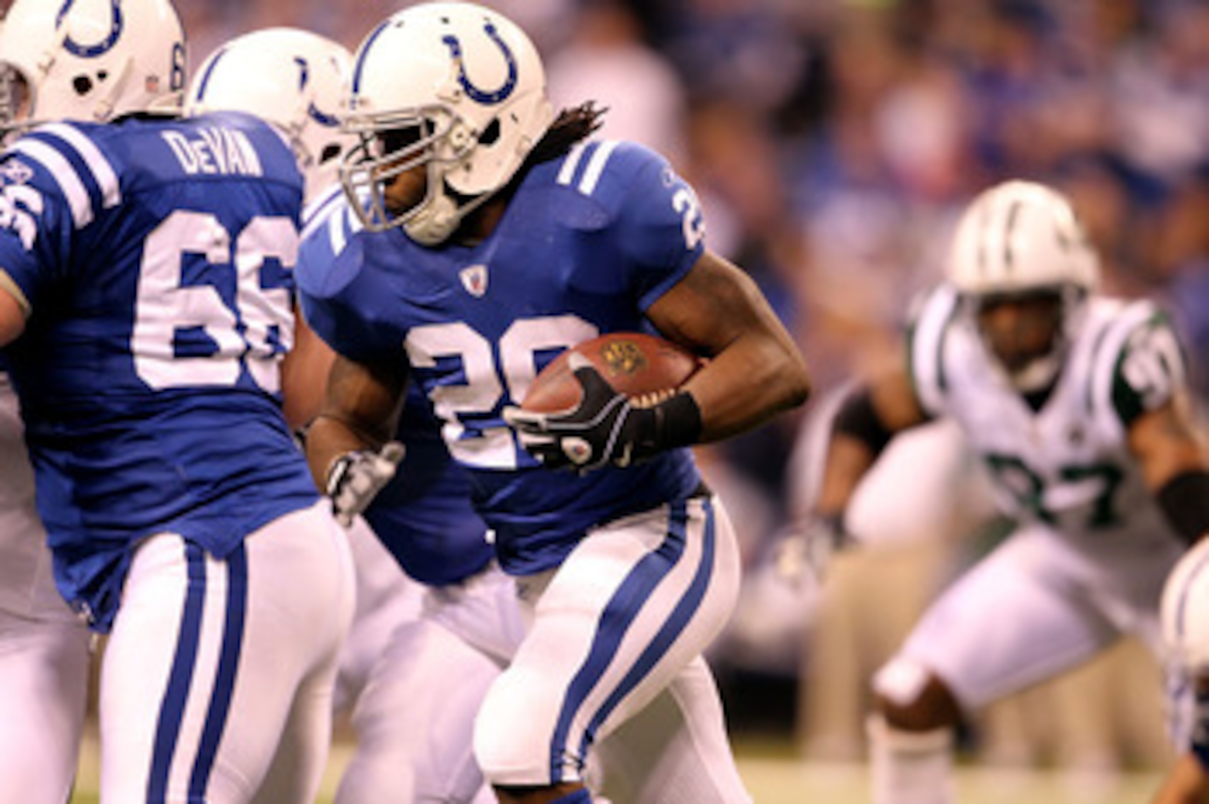 INDIANAPOLIS, IN - JANUARY 08:  Joseph Addai #29 of the Indianapolis Colts runs the ball against the New York Jets during their 2011 AFC wild card playoff game at Lucas Oil Stadium on January 8, 2011 in Indianapolis, Indiana. The Jets won 17-16. (Photo by