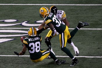 ARLINGTON, TX - FEBRUARY 06:  Tramon Williams #38 of the Green Bay Packers muffs a punt as Sam Shields #37 and Keenan Lewis #23 of the Pittsburgh Steelers attempt to recover during Super Bowl XLV at Cowboys Stadium on February 6, 2011 in Arlington, Texas.