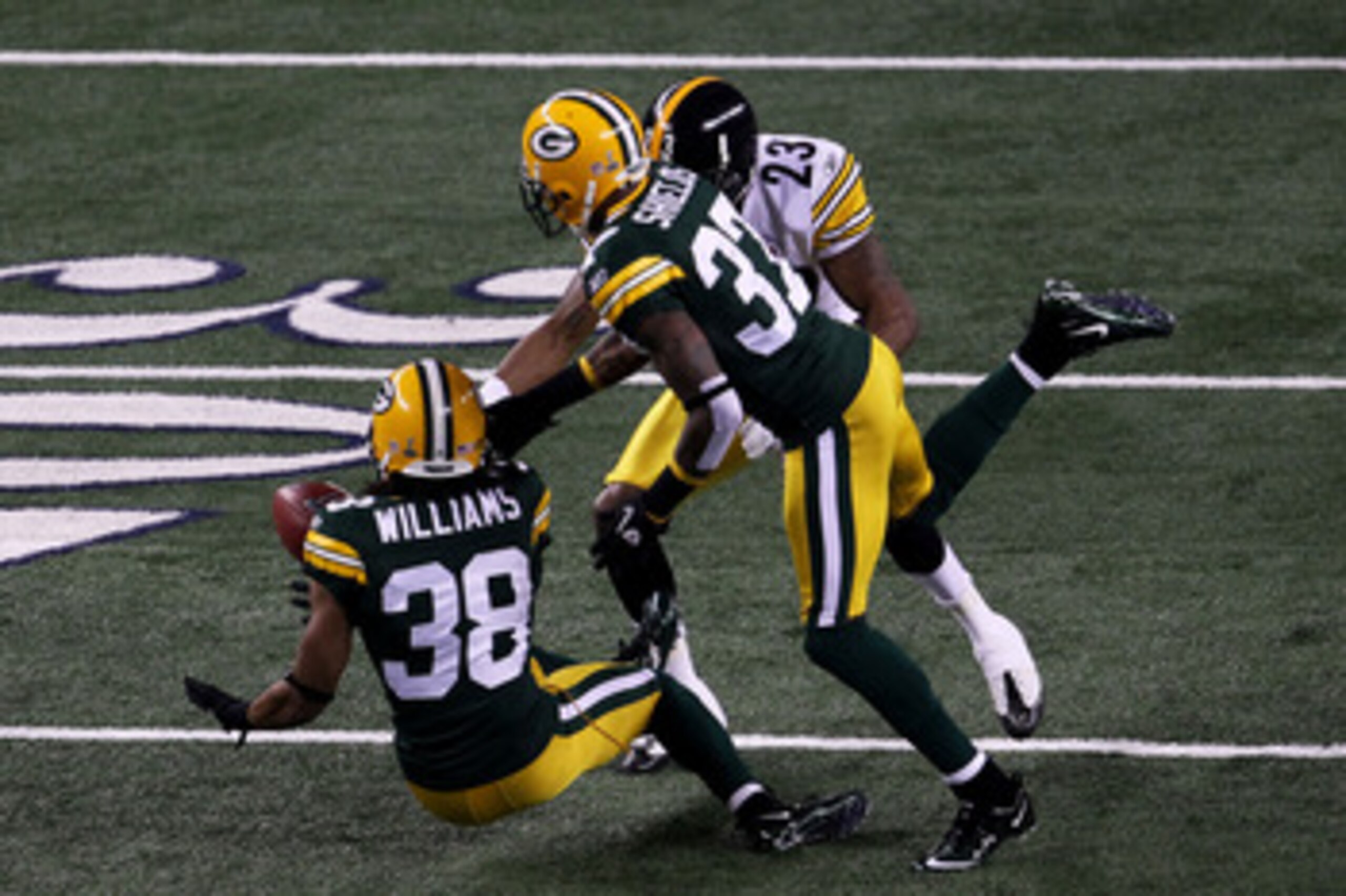 ARLINGTON, TX - FEBRUARY 06: Tramon Williams #38 of the Green Bay Packers muffs a punt as Sam Shields #37 and Keenan Lewis #23 of the Pittsburgh Steelers attempt to recover during Super Bowl XLV at Cowboys Stadium on February 6, 2011 in Arlington, Texas. ARLINGTON, TX - FEBRUARY 06: Tramon Williams #38 of the Green Bay Packers muffs a punt as Sam Shields #37 and Keenan Lewis #23 of the Pittsburgh Steelers attempt to recover during Super Bowl XLV at Cowboys Stadium on February 6, 2011 in Arlington, Texas.