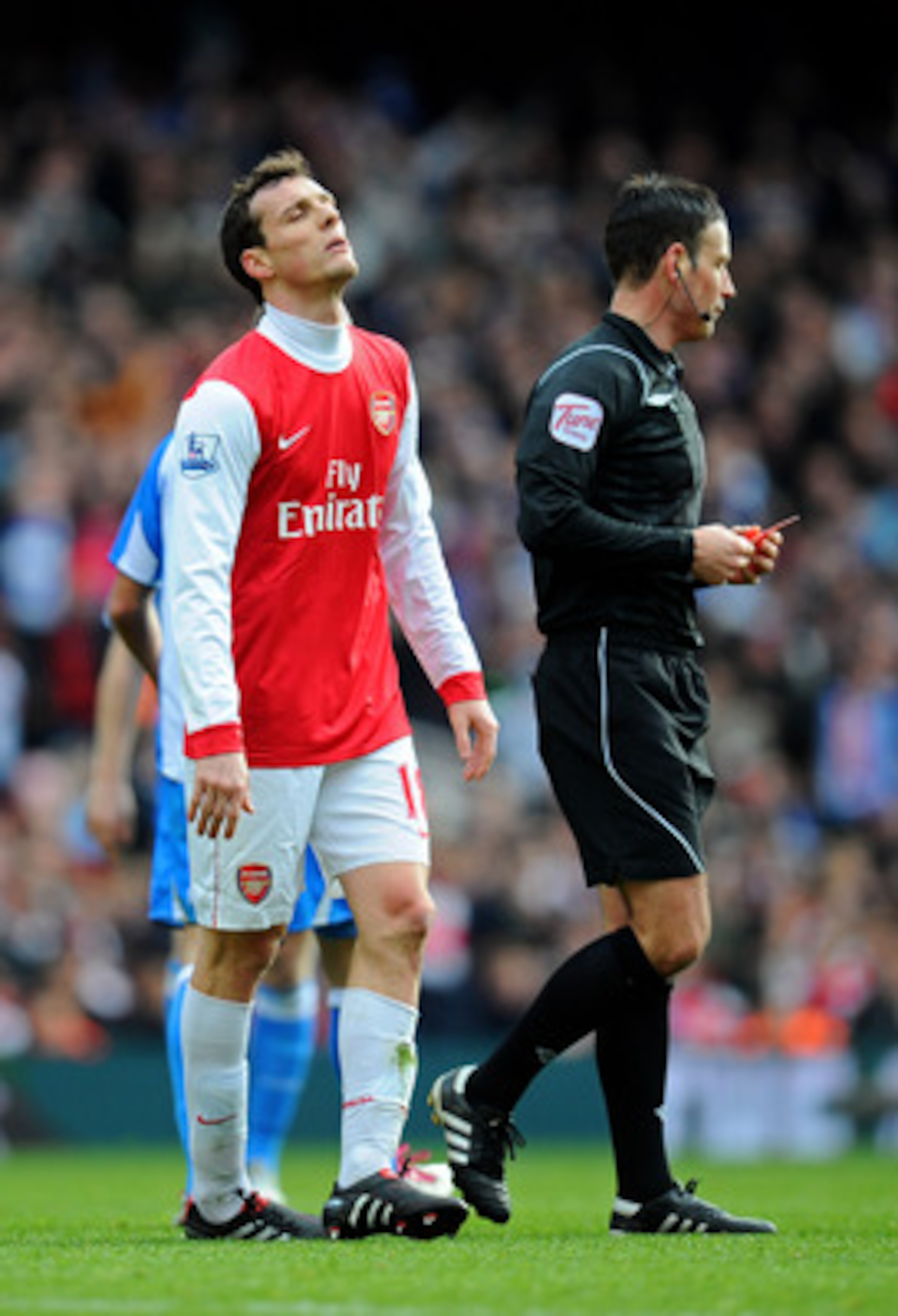 LONDON, ENGLAND - JANUARY 30: Sebastien Squillaci #30 of Arsenal reacts after he is shown a straight red card by Referee Mark Clattenburg after his foul on Jack Hunt of Huddersfield during the FA Cup sponsored by E.ON fourth round match between Arsenal a LONDON, ENGLAND - JANUARY 30: Sebastien Squillaci #30 of Arsenal reacts after he is shown a straight red card by Referee Mark Clattenburg after his foul on Jack Hunt of Huddersfield during the FA Cup sponsored by E.ON fourth round match between Arsenal a