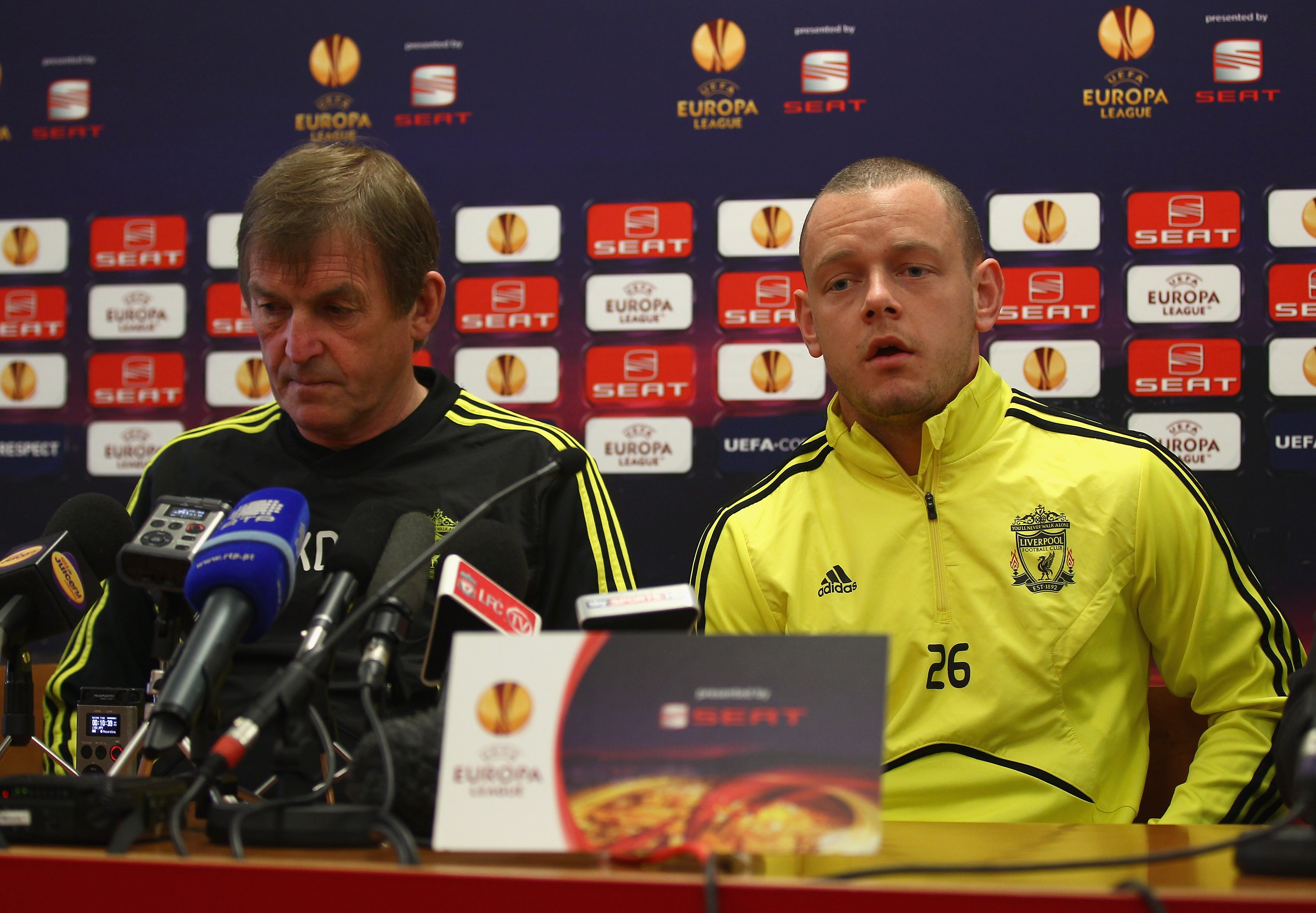 LIVERPOOL, ENGLAND - MARCH 16:  Liverpool manager Kenny Dalglish listens as Jay Spearing answers a question during a press conference ahead of their UEFA Europa League Round of 16 second leg match against Braga at Melwood Training Ground on March 16, 2010