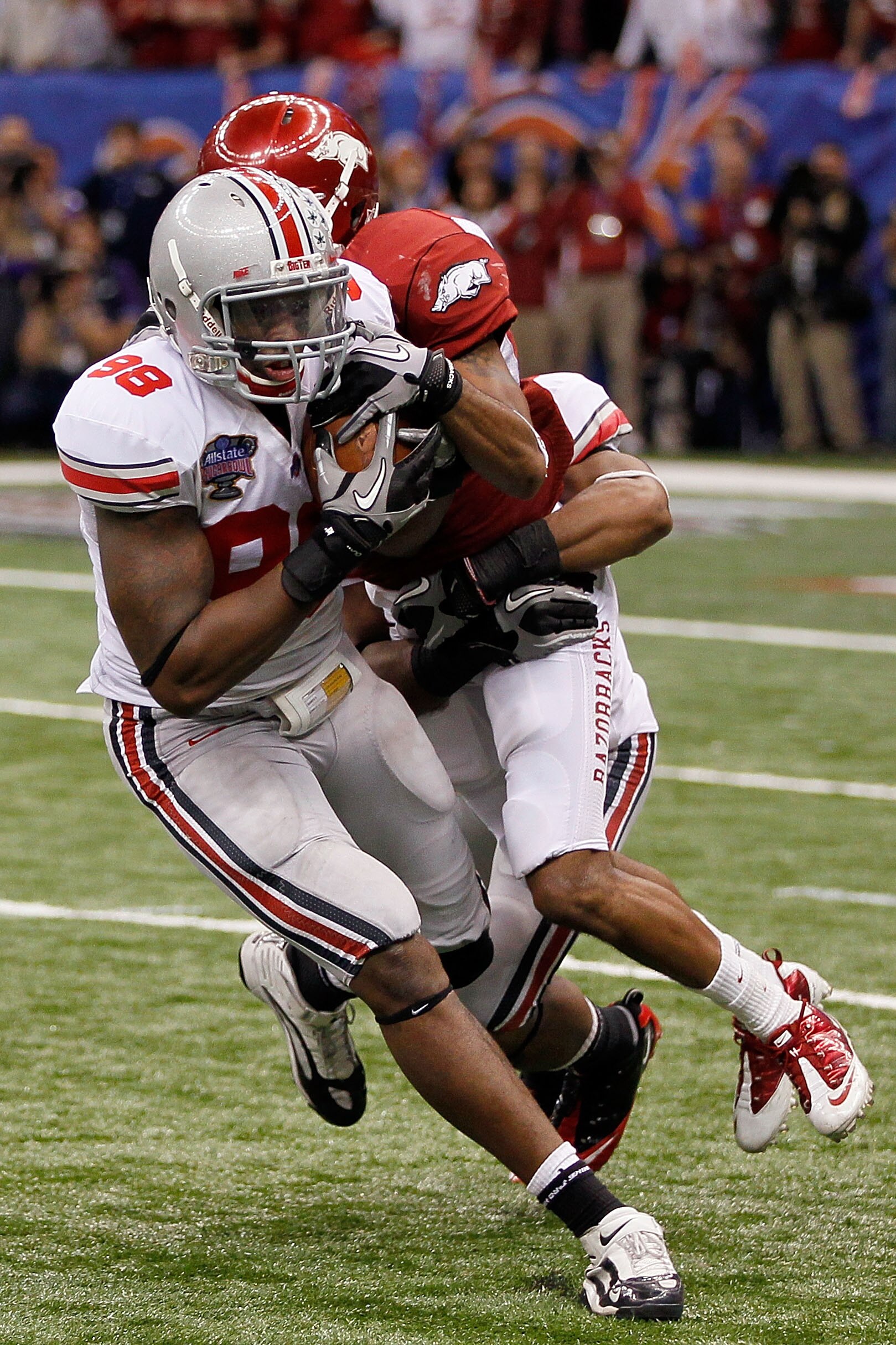NEW ORLEANS, LA - JANUARY 04:  Solomon Thomas #98 of the Ohio State Buckeyes intercepts a pass as he is tackled by Jarius Wright #4 of the Arkansas Razorbacks to seal the 31-26 victory for the Buckeyes against the Razorbacks in the Allstate Sugar Bowl at 