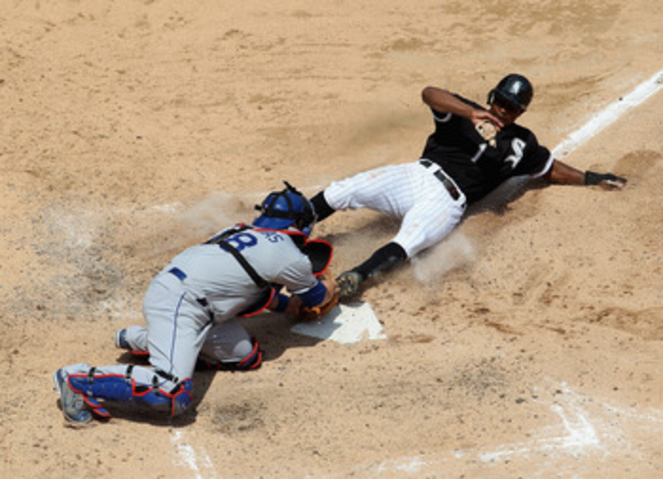 CHICAGO, IL - MAY 22: Juan Pierre #1 of the Chicago White Sox slides into home plate to score a run ahead of the tag by Rod Barajas #28 of the Los Angeles Dodgers in the 4th inning at U.S. Cellular Field on May 22, 2011 in Chicago, Illinois. (Photo by Jon