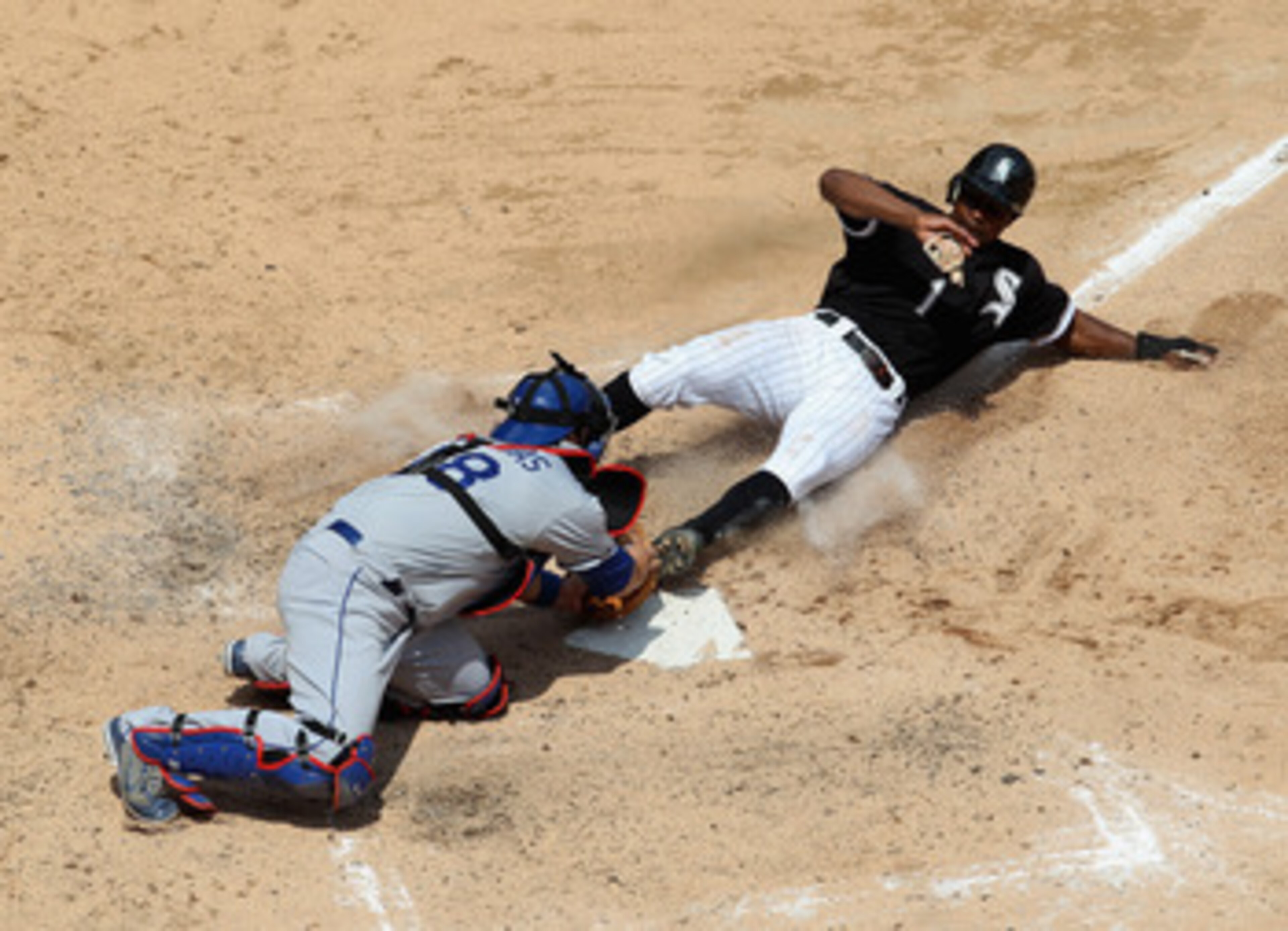 CHICAGO, IL - MAY 22: Juan Pierre #1 of the Chicago White Sox slides into home plate to score a run ahead of the tag by Rod Barajas #28 of the Los Angeles Dodgers in the 4th inning at U.S. Cellular Field on May 22, 2011 in Chicago, Illinois. (Photo by Jon