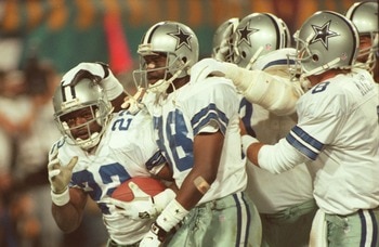 28 Jan 1996:  Running back Emmitt Smith #22 of the Dallas Cowboys is congratulated by teammates, including wide receiver Michael Irvin #88 and quarterback Troy Aikman #8, after scoring his second touchdown of the game in the fourth quarter of Super Bowl X