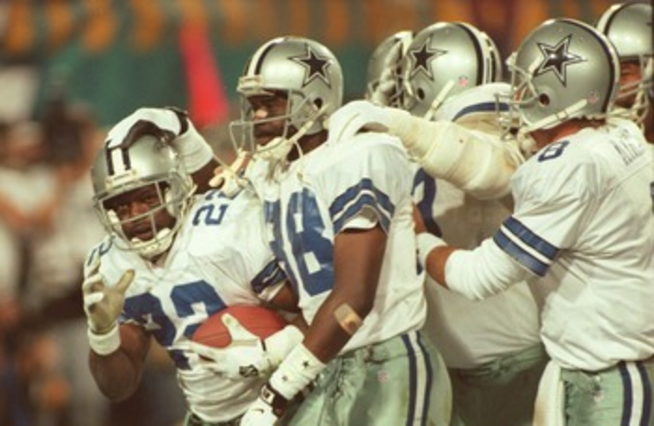 28 Jan 1996:  Running back Emmitt Smith #22 of the Dallas Cowboys is congratulated by teammates, including wide receiver Michael Irvin #88 and quarterback Troy Aikman #8, after scoring his second touchdown of the game in the fourth quarter of Super Bowl X