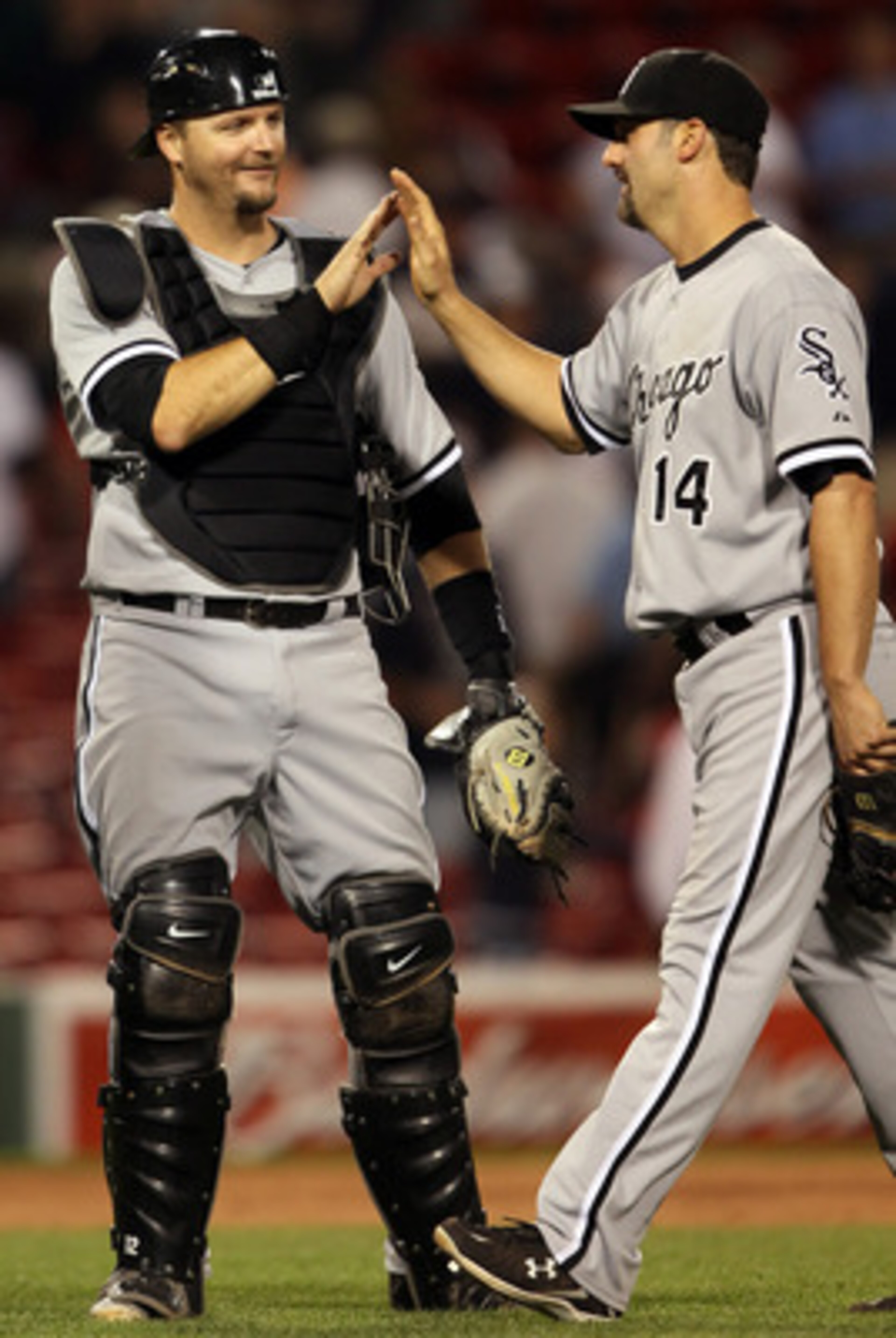 BOSTON, MA - MAY 31:  A.J. Pierzynski #12 of the Chicago White Sox celebrates the win with teammate Paul Konerko #14 after the game against the Boston Red Sox on May 31, 2011 at Fenway Park in Boston, Massachusetts. The Chicago White Sox defeated the Bost