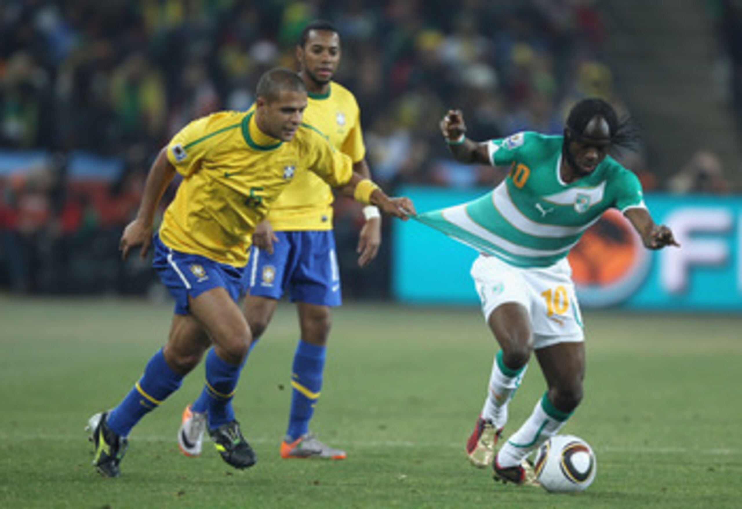 JOHANNESBURG, SOUTH AFRICA - JUNE 20: Felipe Melo of Brazil pulls at the shirt of Gervinho of Ivory Coast during the 2010 FIFA World Cup South Africa Group G match between Brazil and Ivory Coast at Soccer City Stadium on June 20, 2010 in Johannesburg, Sou