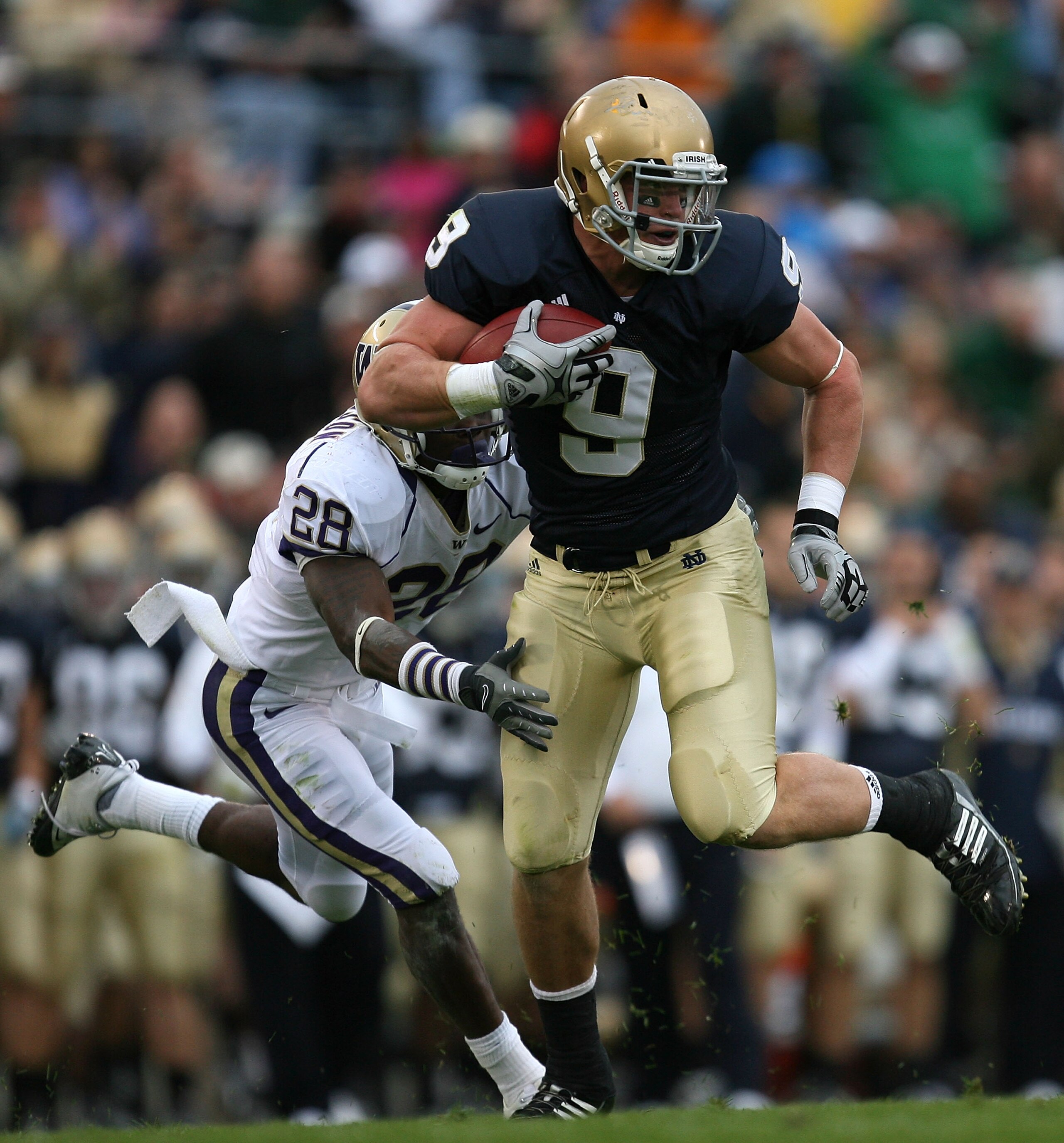SOUTH BEND, IN - OCTOBER 03: Kyle Rudolph #9 of the Notre Dame Fighting Irish breaks away from Quinton Rochardson #28 of the Washington Huskies after catching the ball on October 3, 2009 at Notre Dame Stadium in South Bend, Indiana. (Photo by Jonathan Dan