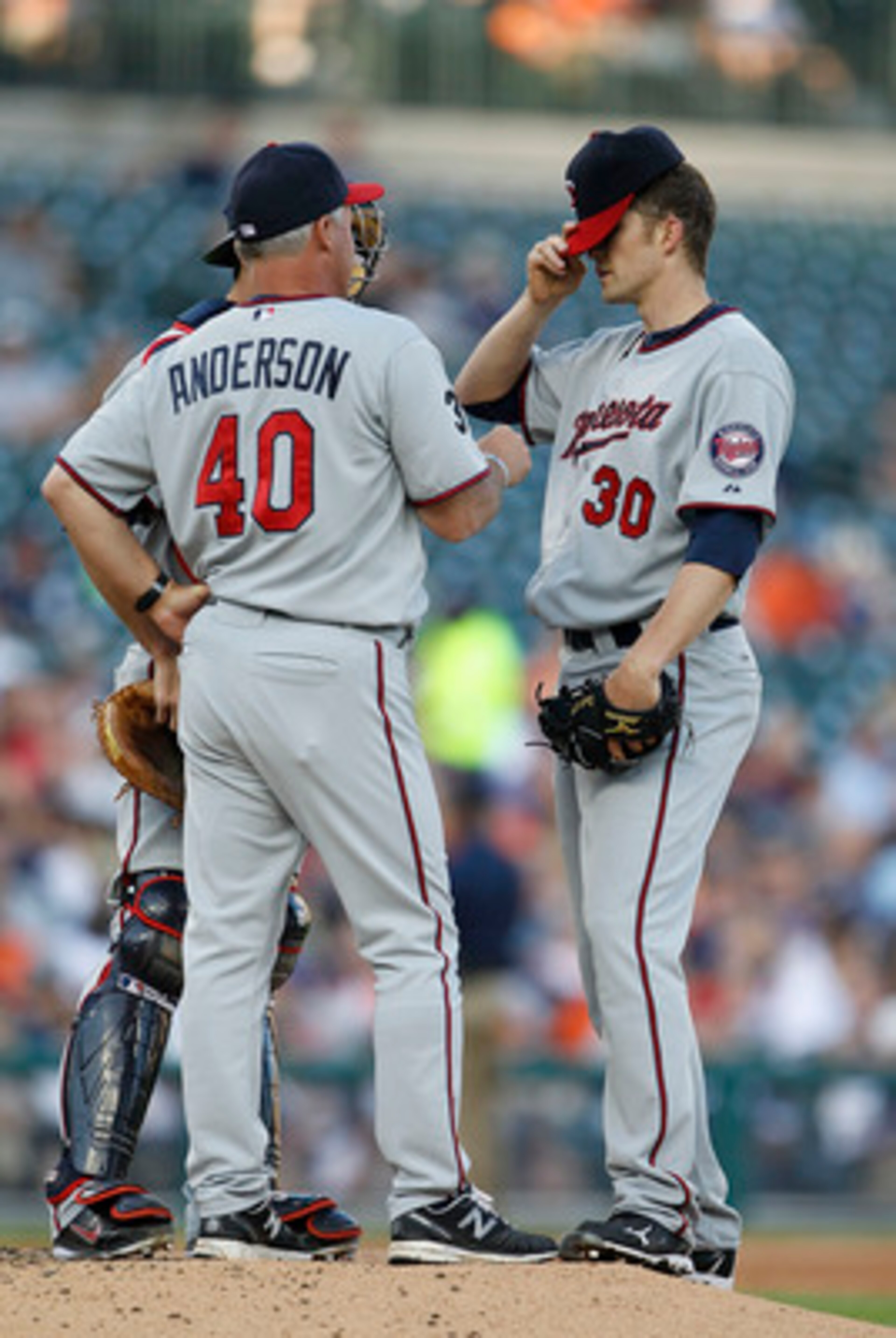 DETROIT - JUNE 01: Minnesota Twins pitching coash Rick Anderson #40 talks with Scott Baker #30 and Drew Butera #41 during the third inning of the game against the Detroit Tigers at Comerica Park on June 1, 2011 in Detroit, Michigan.  (Photo by Leon Halip/