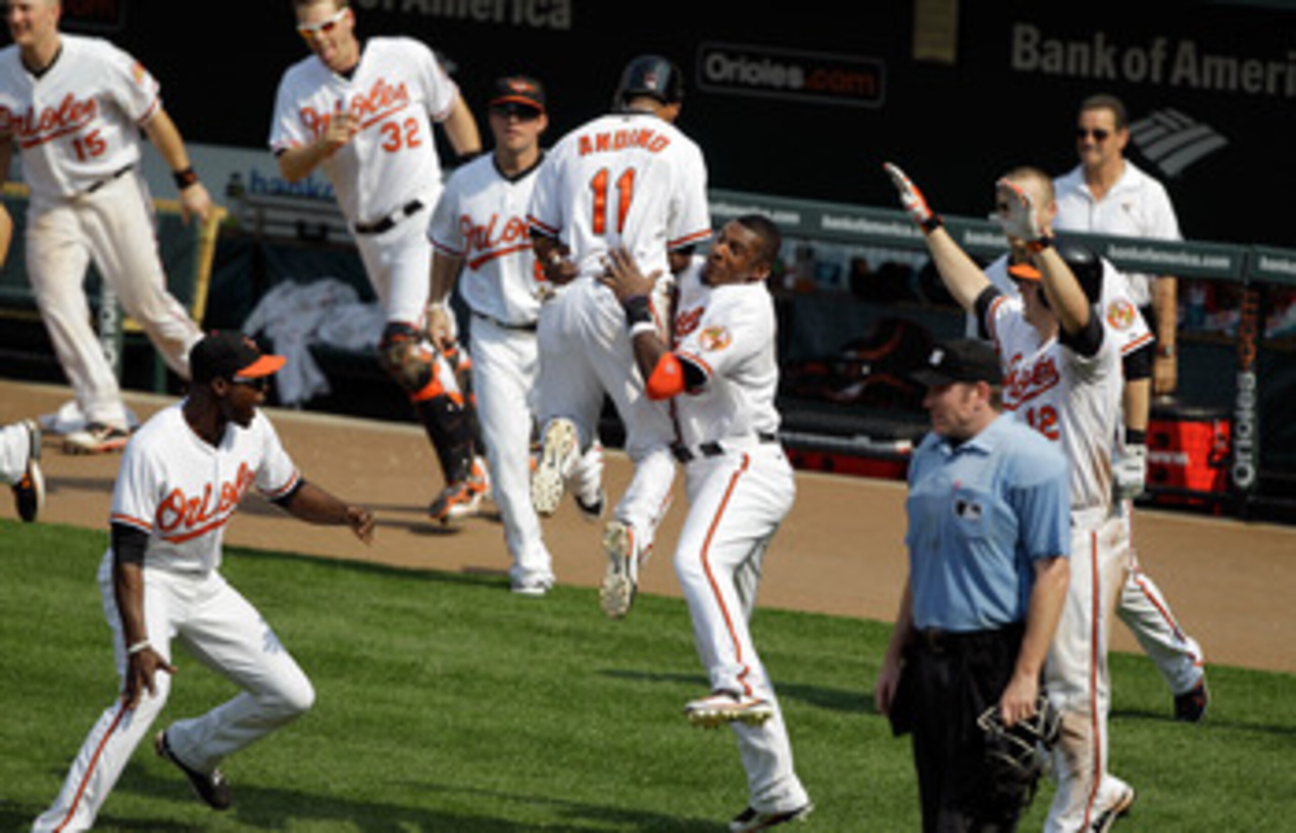 BALTIMORE, MD - MAY 26: Robert Andino #11 of the Baltimore Orioles jumps into the arms of teammate Adam Jones #10 (R) after Andino scored the game winning run to defeat the Kansas City Royals 6-5 in twelve innings at Oriole Park at Camden Yards on May 26, BALTIMORE, MD - MAY 26: Robert Andino #11 of the Baltimore Orioles jumps into the arms of teammate Adam Jones #10 (R) after Andino scored the game winning run to defeat the Kansas City Royals 6-5 in twelve innings at Oriole Park at Camden Yards on May 26,