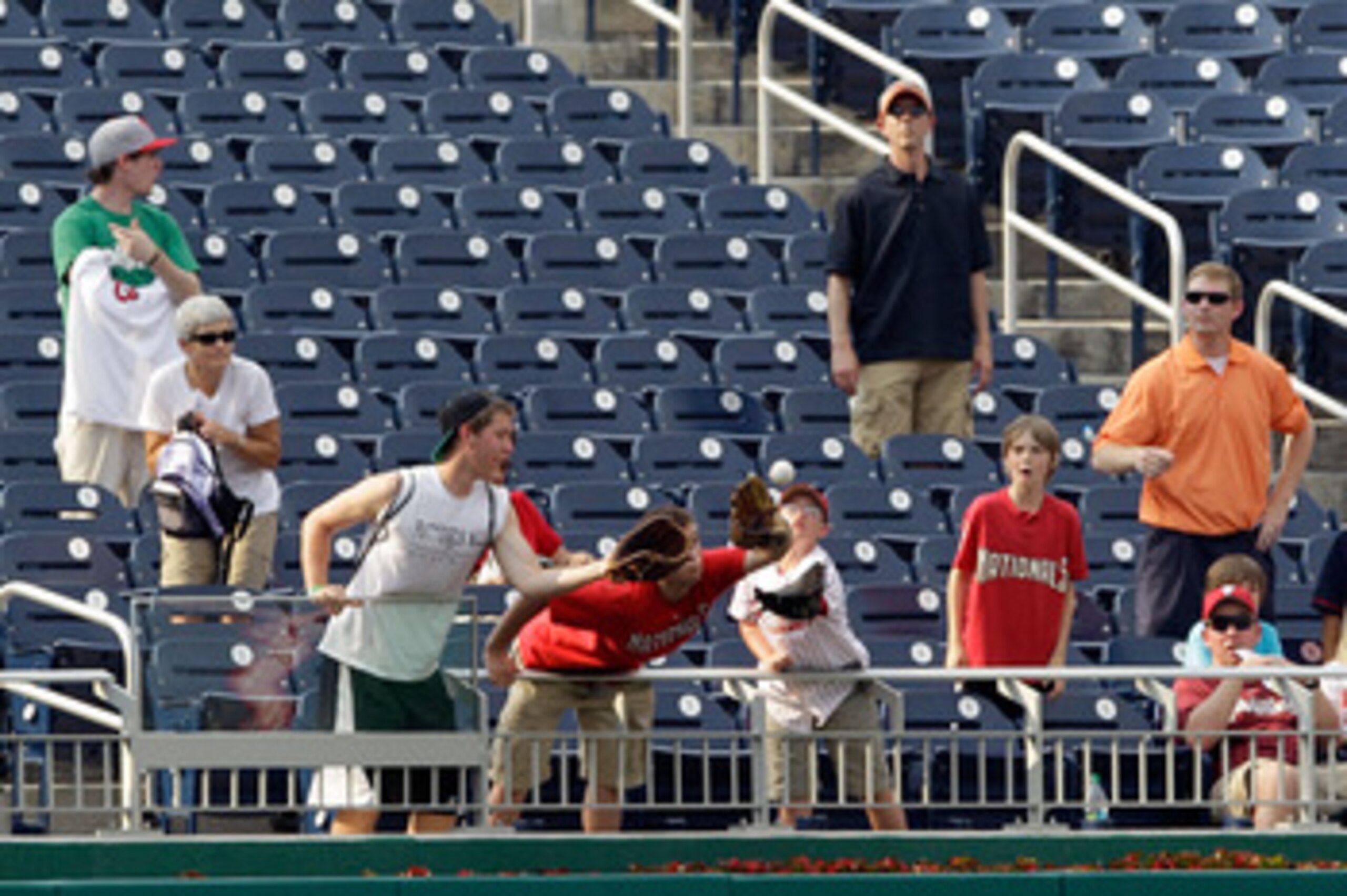 WASHINGTON, DC - MAY 31: Fans catch a homerun during batting practice before the start of the Washington Nationals and Philadelphia Phillies game at Nationals Park on May 31, 2011 in Washington, DC.  (Photo by Rob Carr/Getty Images)