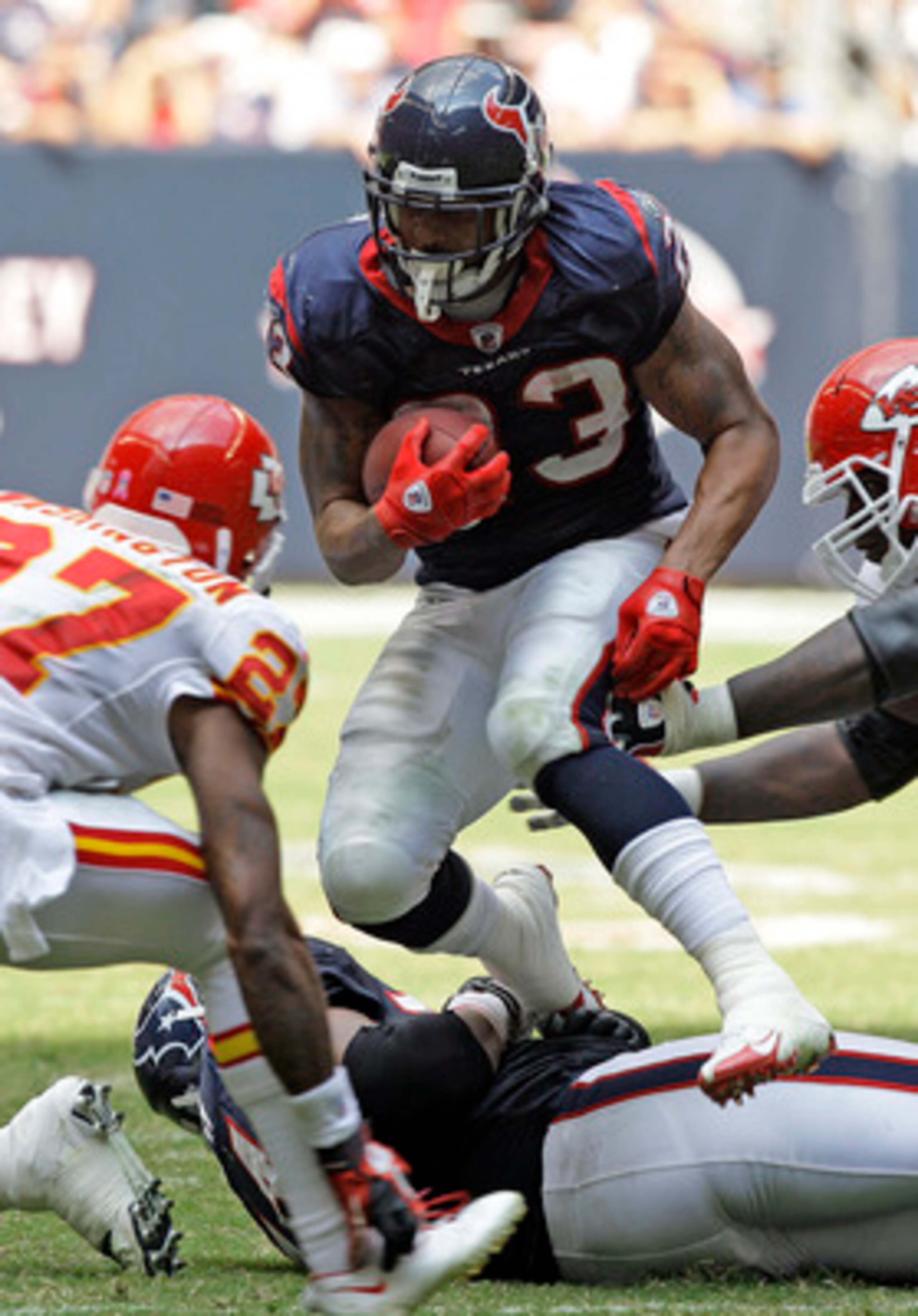 HOUSTON - OCTOBER 17: Running back Adrian Foster #23 of the Houston Texans looks for room to run as cornerback Donald Washington #27 and Glenn Dorsey #72 of the Kasnsas City Chiefs at Reliant Stadium on October 17, 2010 in Houston, Texas. (Photo by Bob HOUSTON - OCTOBER 17: Running back Adrian Foster #23 of the Houston Texans looks for room to run as cornerback Donald Washington #27 and Glenn Dorsey #72 of the Kasnsas City Chiefs at Reliant Stadium on October 17, 2010 in Houston, Texas. (Photo by Bob