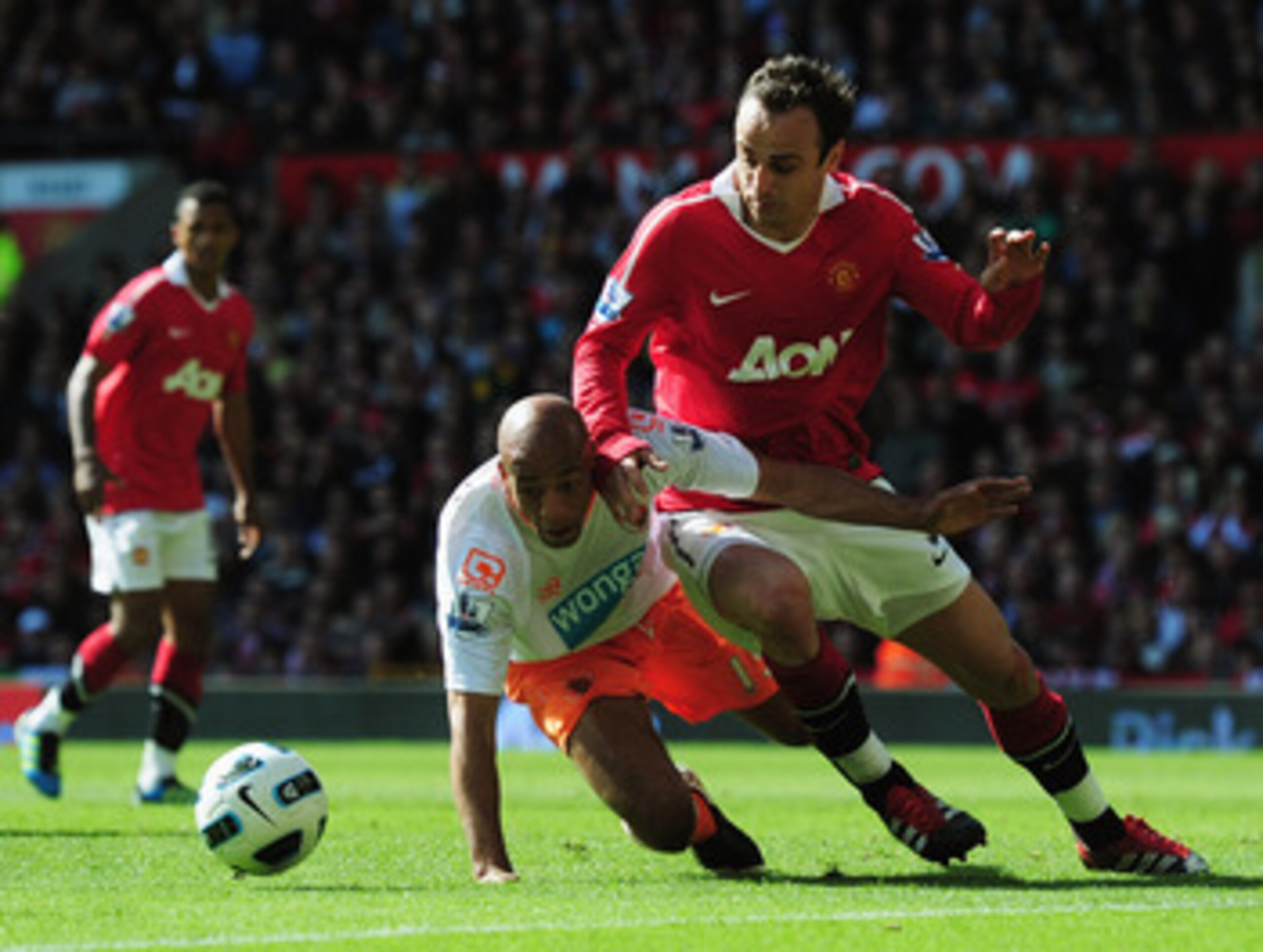 MANCHESTER, ENGLAND - MAY 22:  Dimitar Berbatov of Manchester United battles withAlex John-Baptiste of Blackpool during the Barclays Premier League match between Manchester United and Blackpool at Old Trafford on May 22, 2011 in Manchester, England.  (Pho