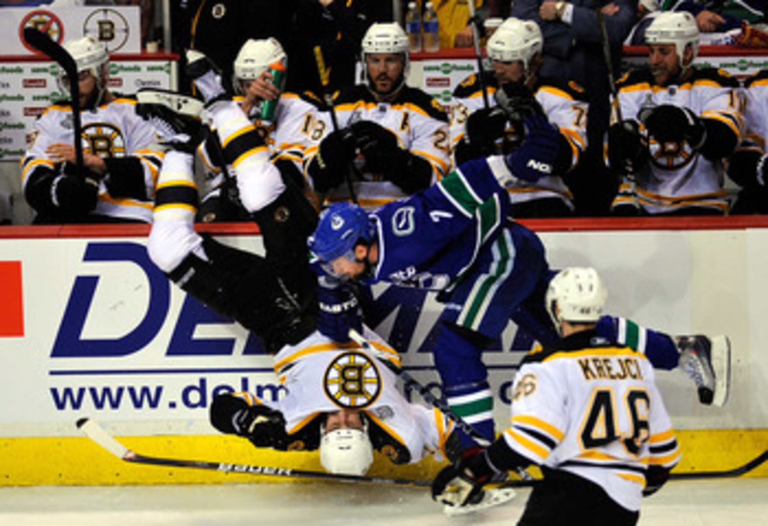 VANCOUVER, BC - JUNE 01:  Milan Lucic #17 of the Boston Bruins gets flipped after being check by Dan Hamhuis #2 of the Vancouver Canucks during game one of the 2011 NHL Stanley Cup Finals at Rogers Arena on June 1, 2011 in Vancouver, Canada.  (Photo by Ri