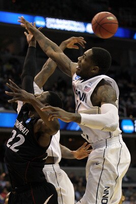 WASHINGTON - MARCH 19:  Alex Oriakhi #34 of the Connecticut Huskies and Rashad Bishop #22 of the Cincinnati Bearcats fight for a rebound during the third round of the 2011 NCAA men's basketball tournament at Verizon Center on March 19, 2011 in Washington,