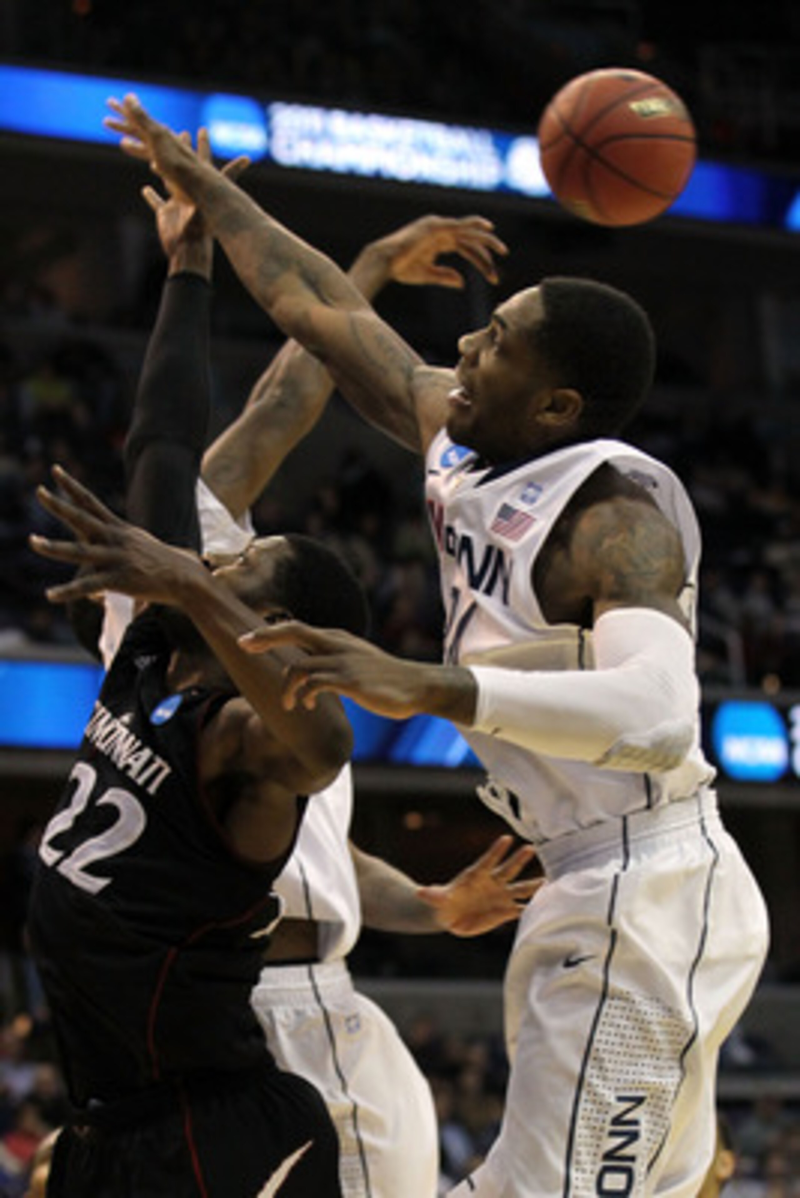 WASHINGTON - MARCH 19: Alex Oriakhi #34 of the Connecticut Huskies and Rashad Bishop #22 of the Cincinnati Bearcats fight for a rebound during the third round of the 2011 NCAA men's basketball tournament at Verizon Center on March 19, 2011 in Washington, WASHINGTON - MARCH 19: Alex Oriakhi #34 of the Connecticut Huskies and Rashad Bishop #22 of the Cincinnati Bearcats fight for a rebound during the third round of the 2011 NCAA men's basketball tournament at Verizon Center on March 19, 2011 in Washington,