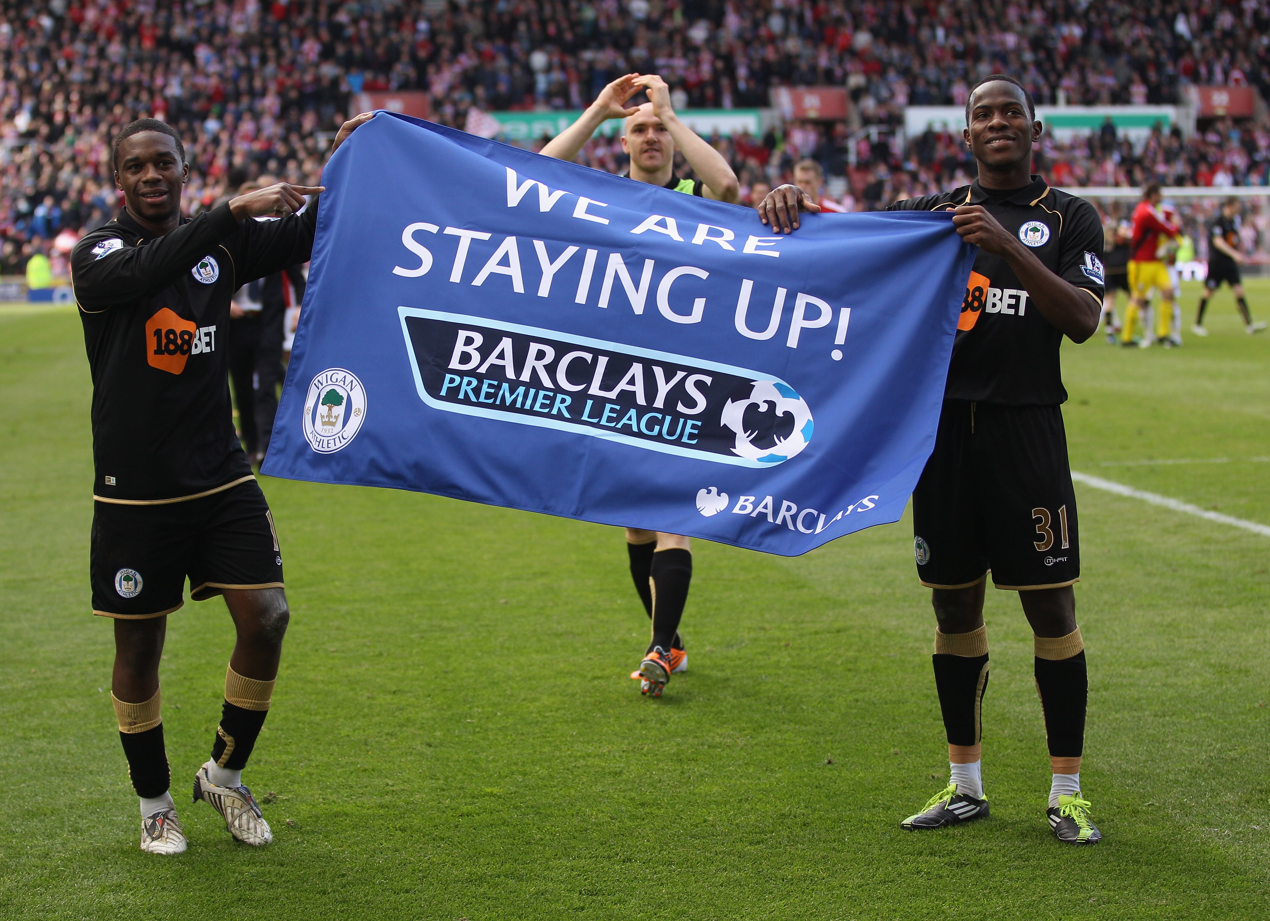 STOKE ON TRENT, ENGLAND - MAY 22:  Charles N'Zogbia  and Maynor Figueroa of Wigan  celebrate staying up during the Barclays Premier League match between Stoke City and Wigan Athletic at Britannia Stadium on May 22, 2011 in Stoke on Trent, England.  (Photo