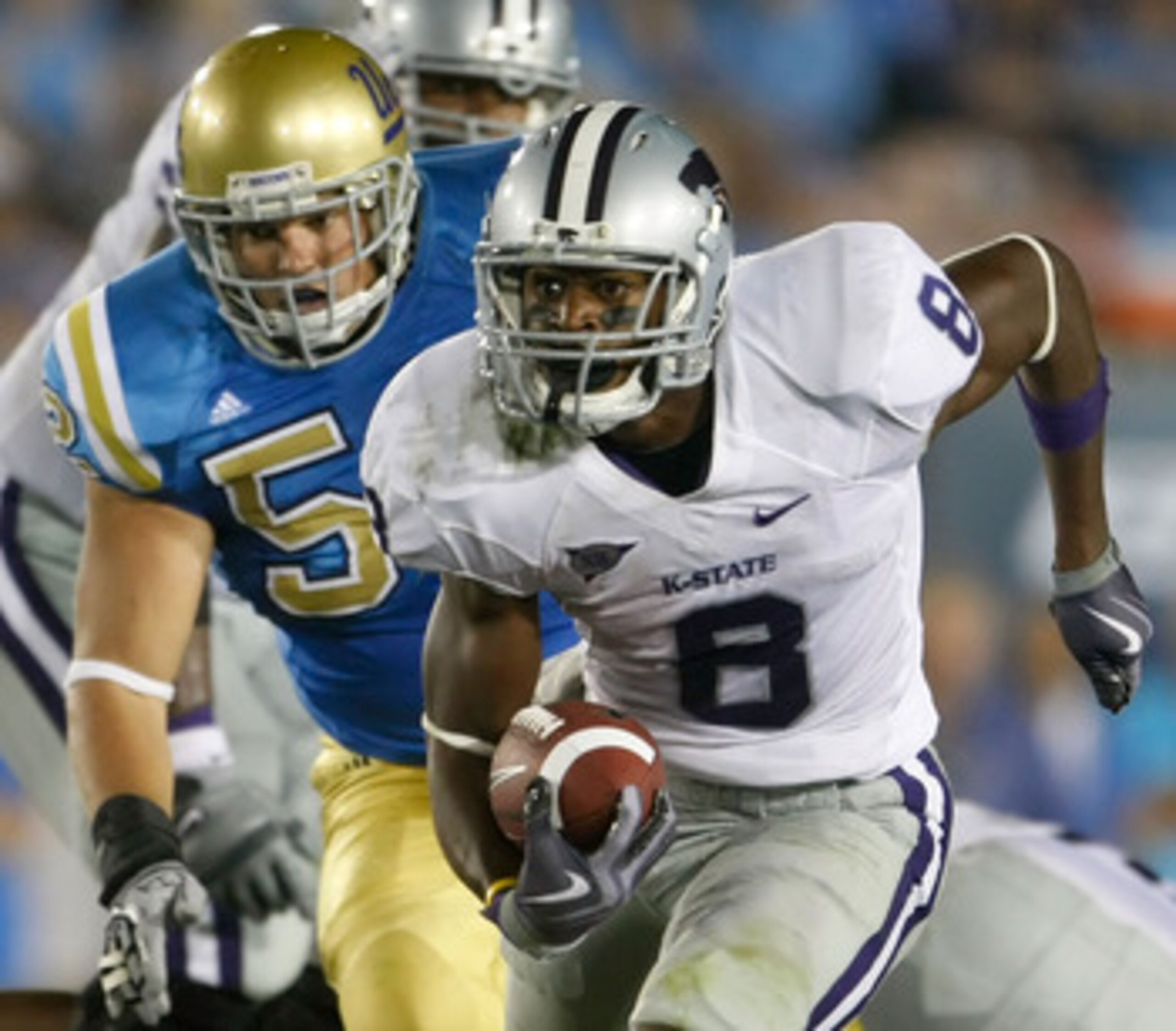 PASADENA, CA - SEPTEMBER 19:  Daniel Thomas #8 of the Kansas State Wildcats is pursued by Jess Ward #52 of the UCLA Bruins in the third quarter at the Rose Bowl on September 19, 2009 in Pasadena, California. UCLA defeated Kansas State 23-9.  (Photo by Jef