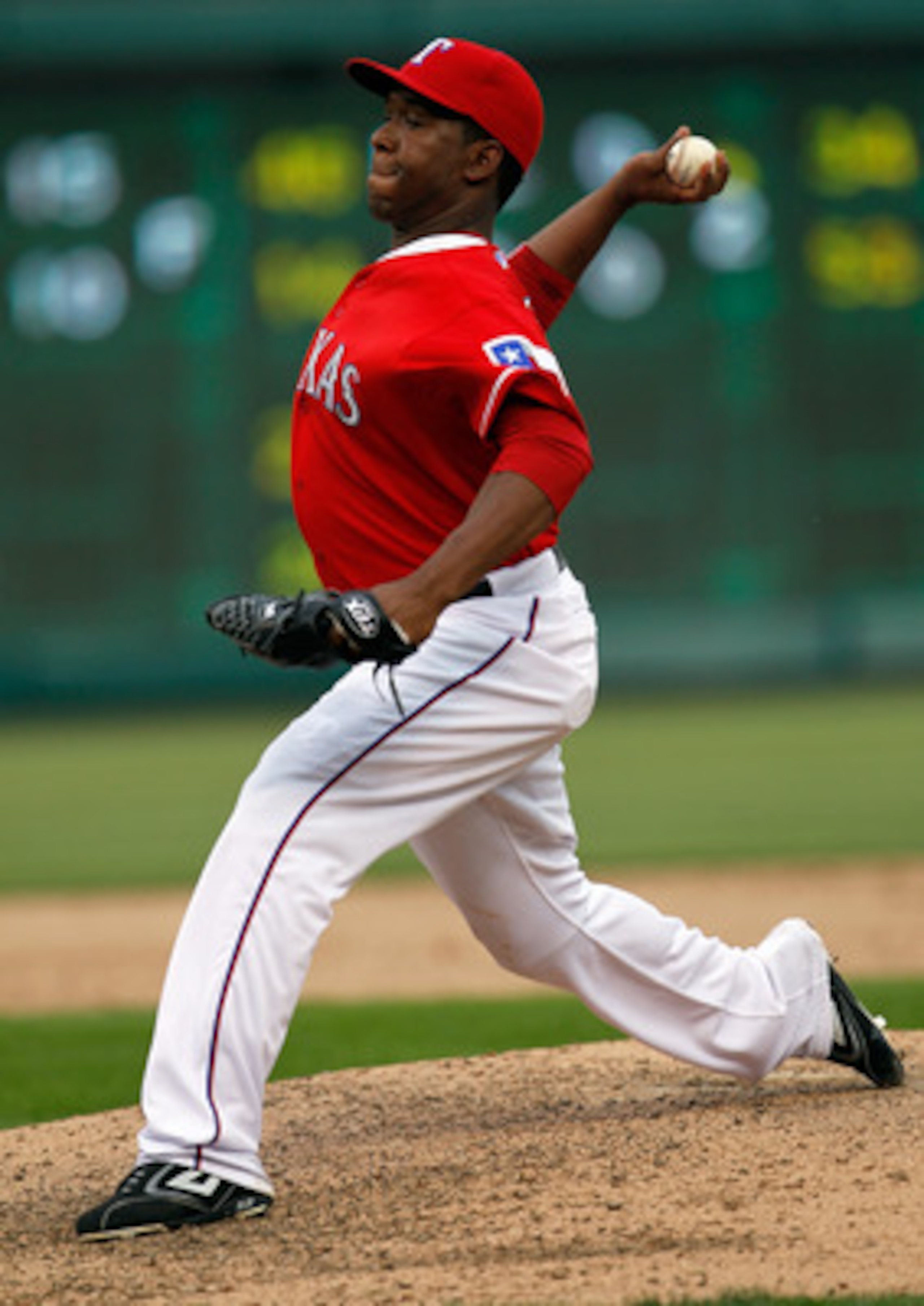 ARLINGTON, TX - APRIL 01:  Closing pitcher Neftali Feliz #30 of the Texas Rangers pitches in the top of the ninth inning against the Boston Red Sox on Opening Day at Rangers Ballpark in Arlington on April 1, 2011 in Arlington, Texas.  (Photo by Tom Pennin