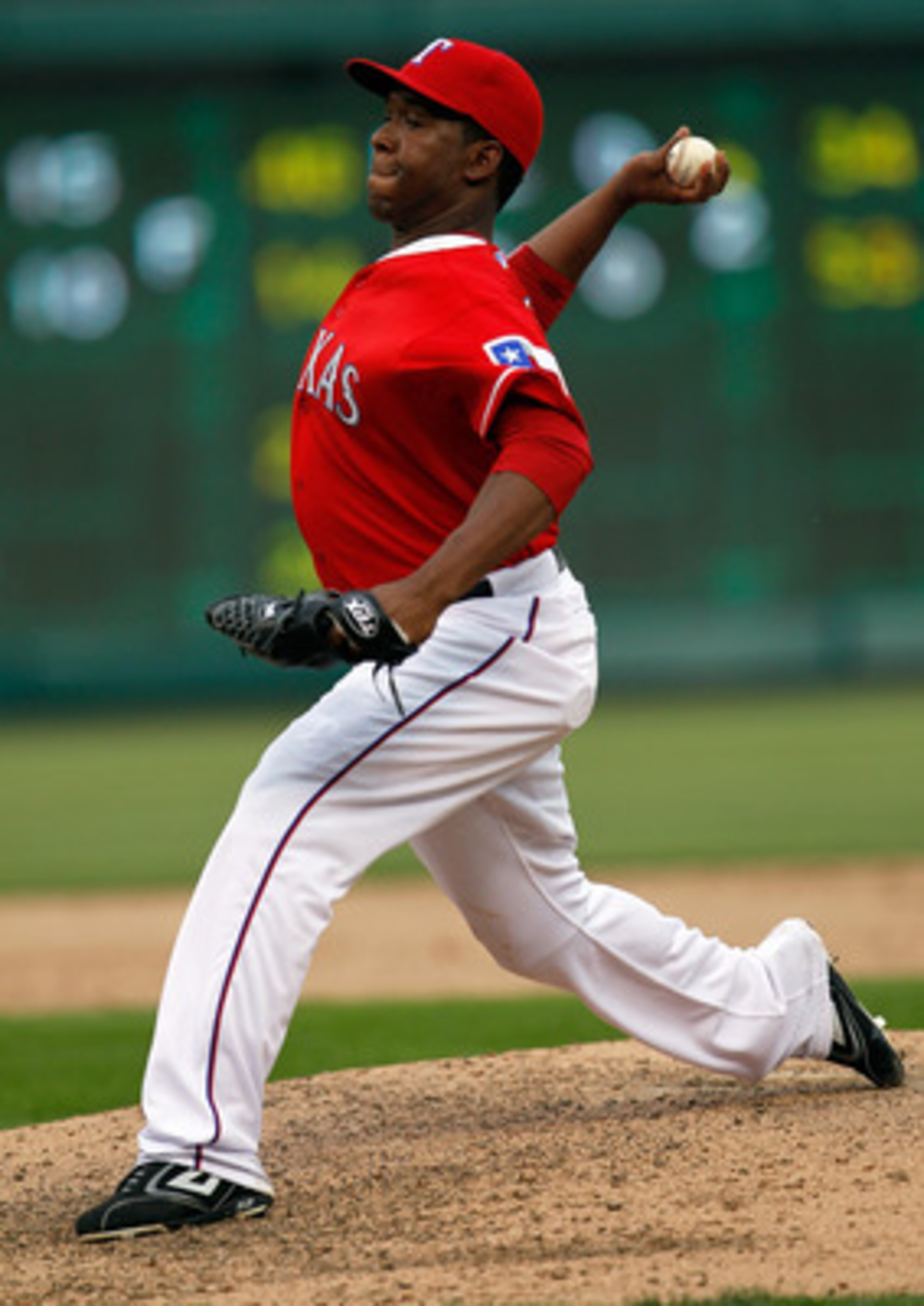 ARLINGTON, TX - APRIL 01:  Closing pitcher Neftali Feliz #30 of the Texas Rangers pitches in the top of the ninth inning against the Boston Red Sox on Opening Day at Rangers Ballpark in Arlington on April 1, 2011 in Arlington, Texas.  (Photo by Tom Pennin