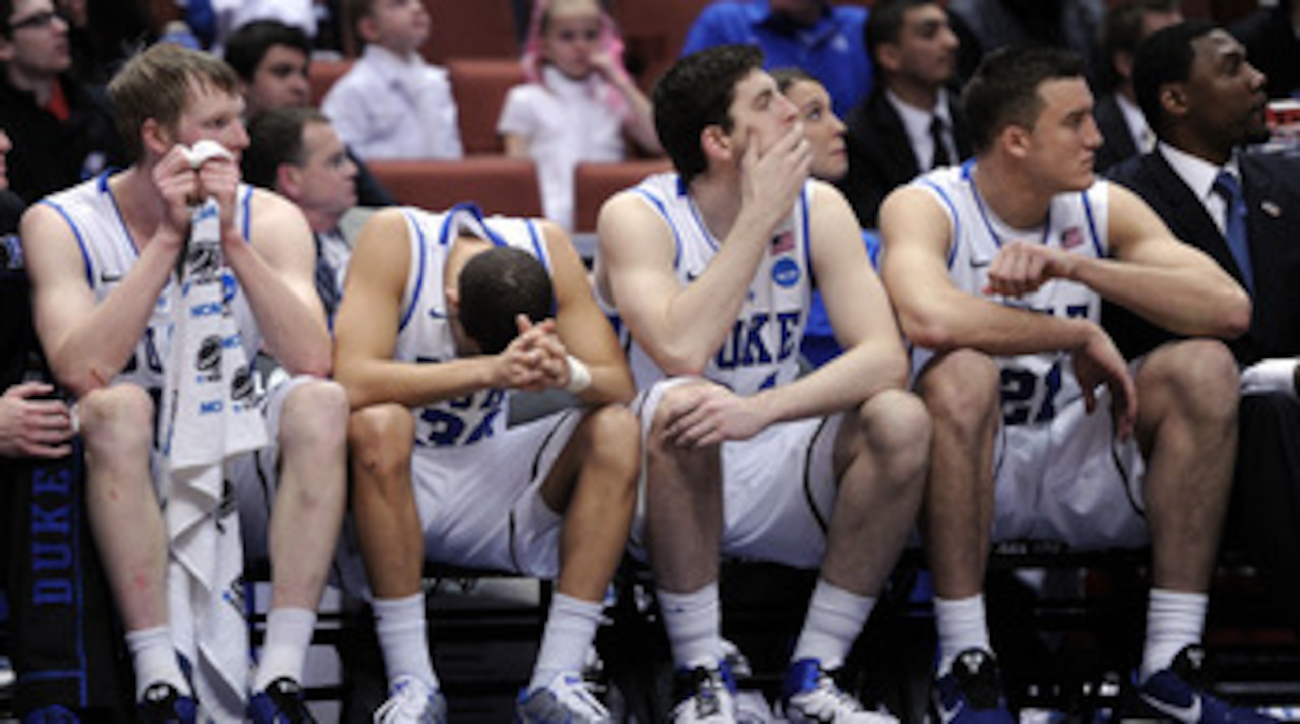 ANAHEIM, CA - MARCH 24:  Kyle Singler #12, Seth Curry #30, Ryan Kelly #34 and Miles Plumlee #21 of the Duke Blue Devils look on from the bench against the Arizona Wildcats during the west regional semifinal of the 2011 NCAA men's basketball tournament at 