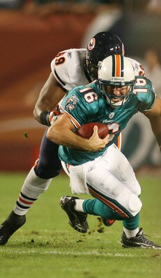 MIAMI - NOVEMBER 18: Quarterback Tyler Thigpen #16 of the Miami Dolphins is sacked by Henry Melton #69 of the Chicago Bears at Sun Life Stadium on November 18, 2010 in Miami, Florida.  (Photo by Marc Serota/Getty Images)