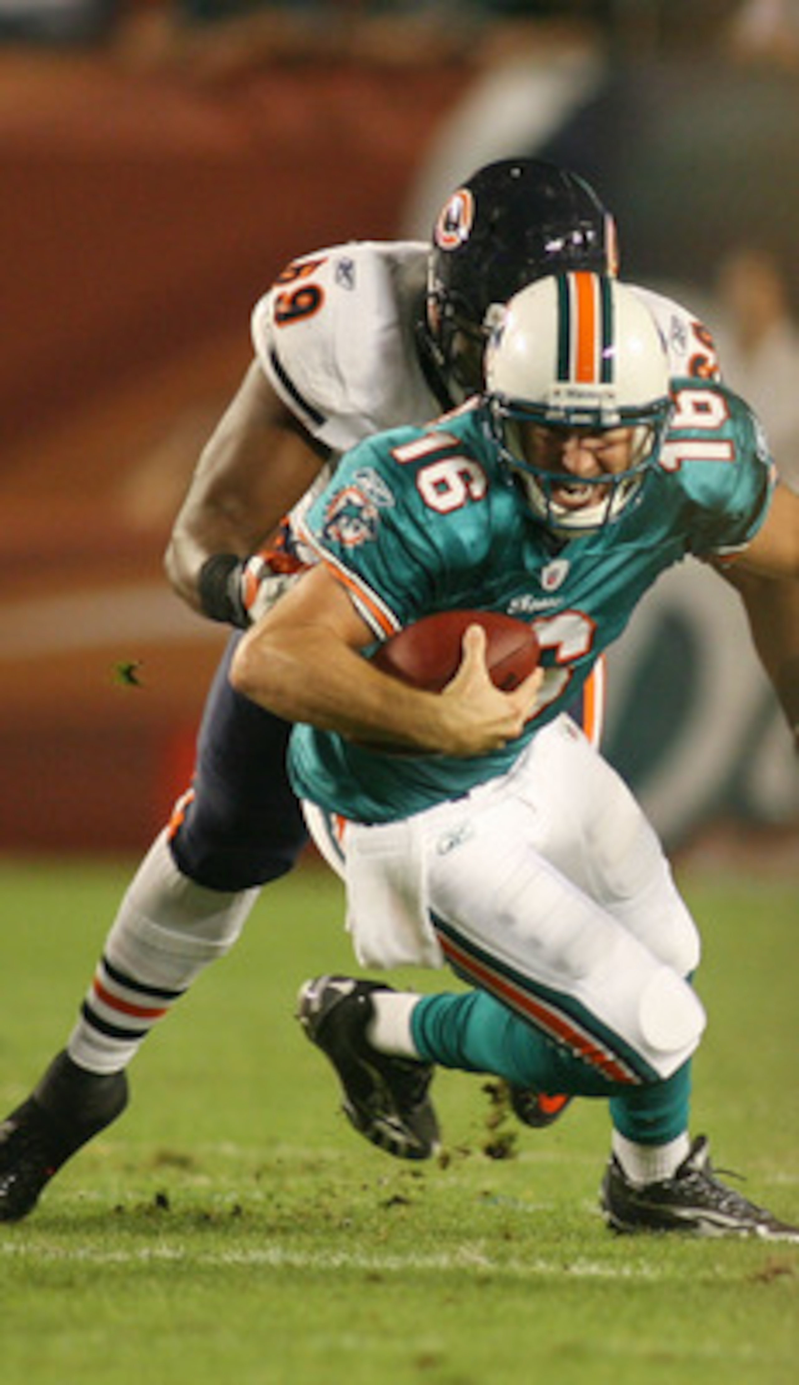 MIAMI - NOVEMBER 18: Quarterback Tyler Thigpen #16 of the Miami Dolphins is sacked by Henry Melton #69 of the Chicago Bears at Sun Life Stadium on November 18, 2010 in Miami, Florida.  (Photo by Marc Serota/Getty Images)
